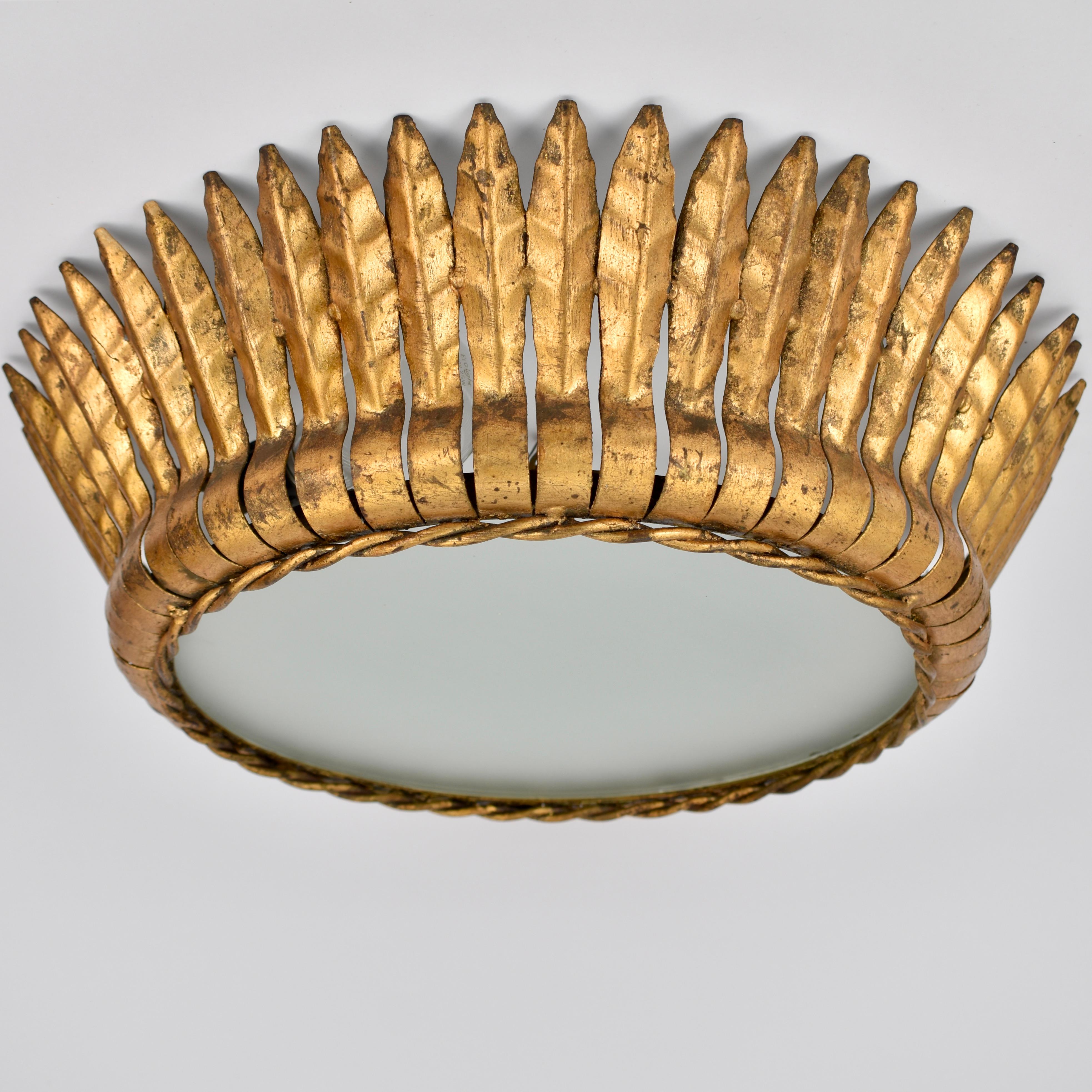 Beautiful 1950s gilded iron flush mount, made in Spain. The frosted glass diffuses the light in a beautiful way. The light has 2 light points, all take an e26 or e27 fitting size lightbulbs. Suitable for led, or edison bulbs. Great vintage