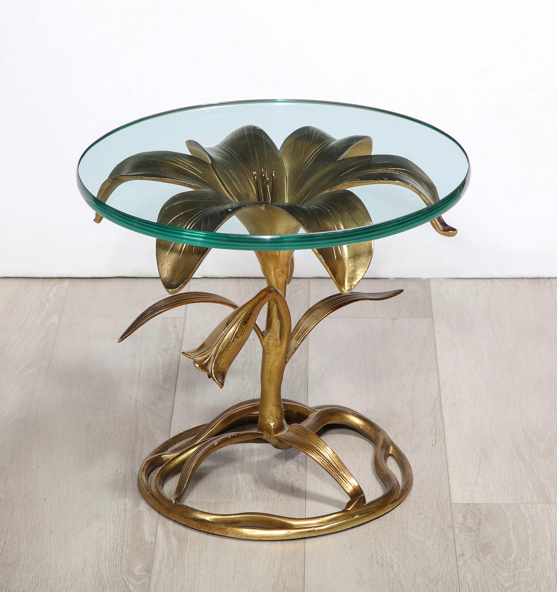 Midcentury gilt aluminum lily form table with glass top.