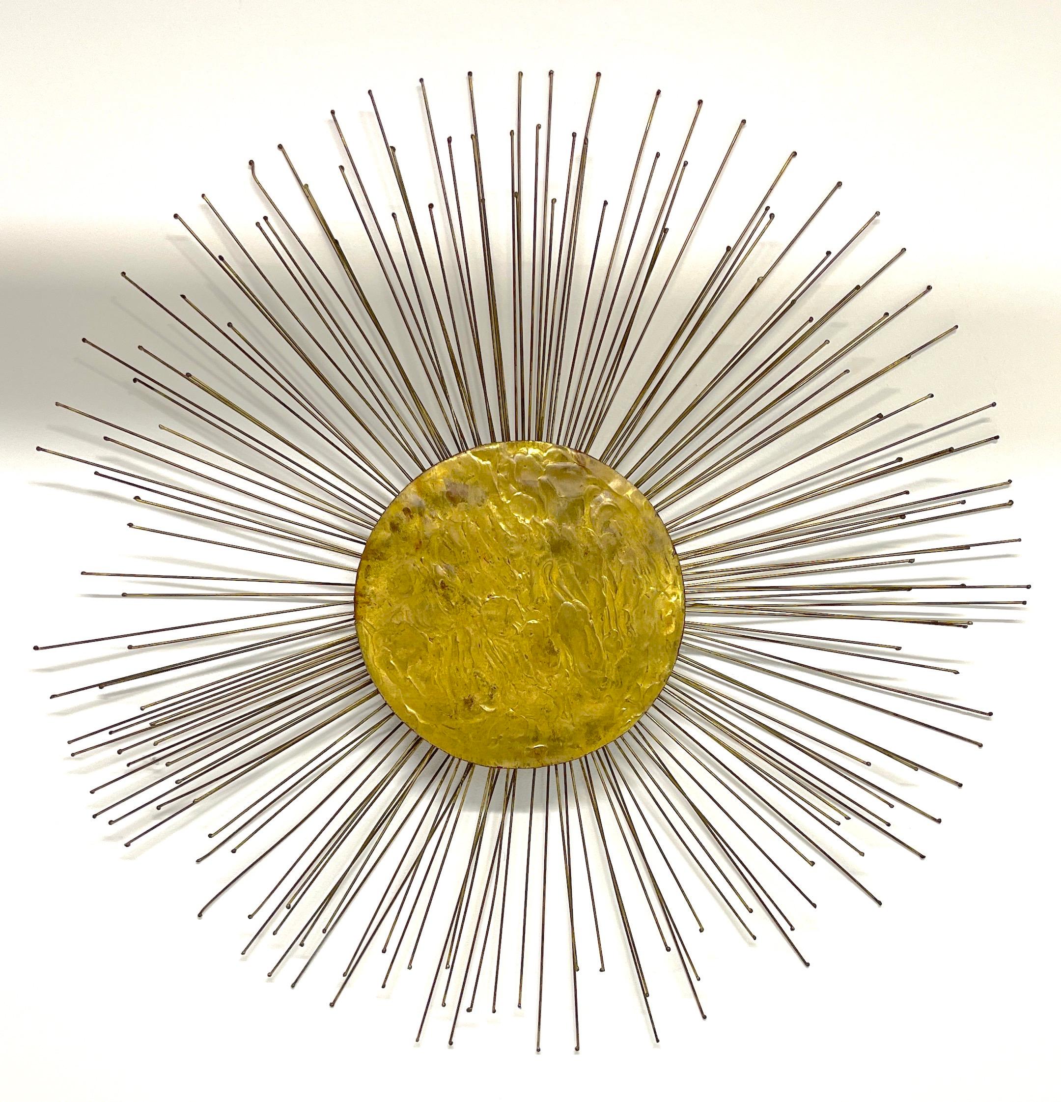 Mid Century Gilt Bronze Sunburst Wall Sculpture, Attributed to William Friedle 
USA, circa 1960s, Unmarked
A nice variation of William Friedle's exceptional metal work, of good size with an overall diameter of 34-inches with a 11.5-inch diameter
