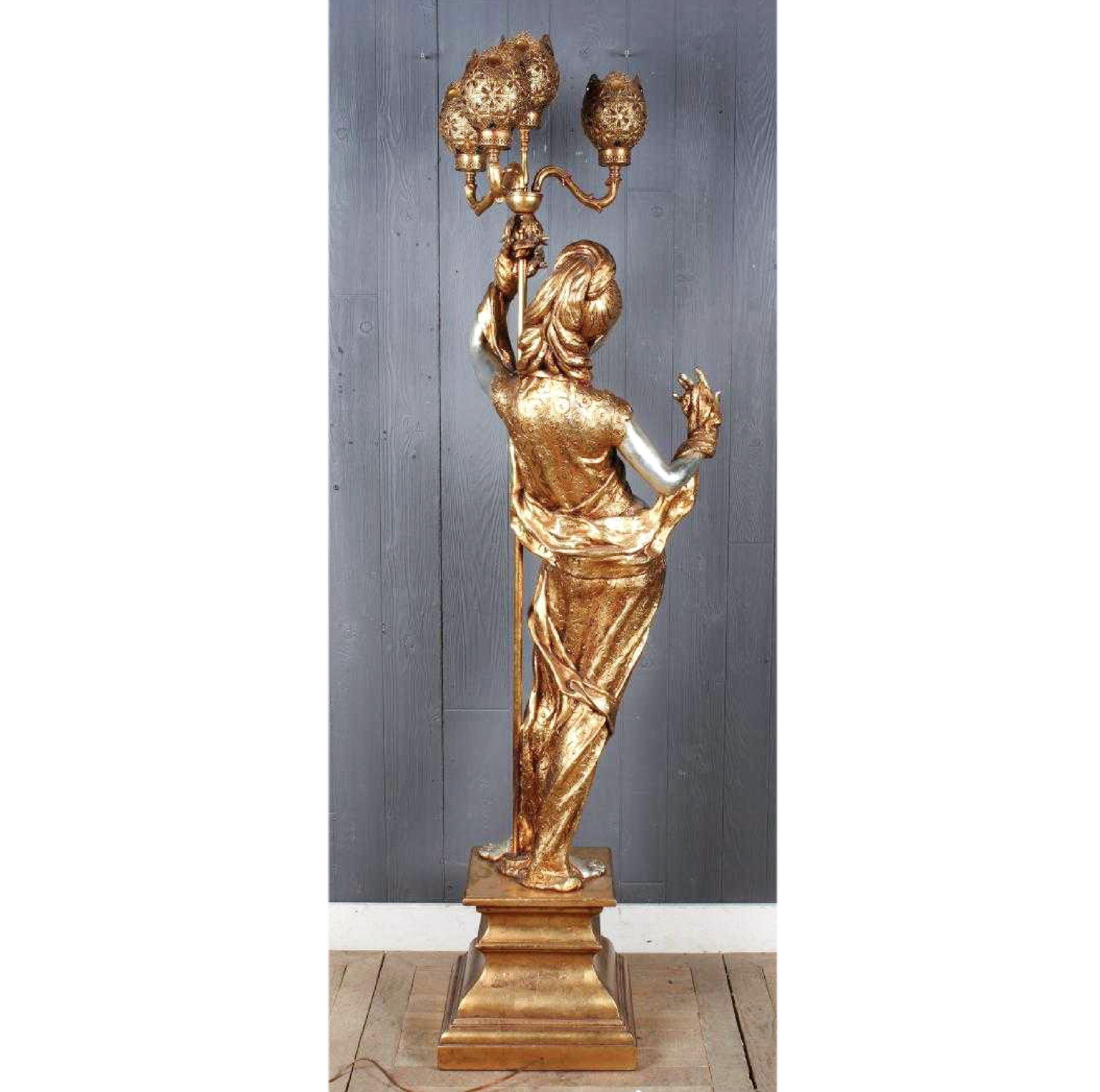 A large indoor figural post lamp in the form of a kitschy classical maiden by Atelier de Recherche Plastique, 'ARP' Copyright mark 'ARP' to the back Gilt ornament accentuate the contraposto and narrowness of the waist as well as the almost medieval
