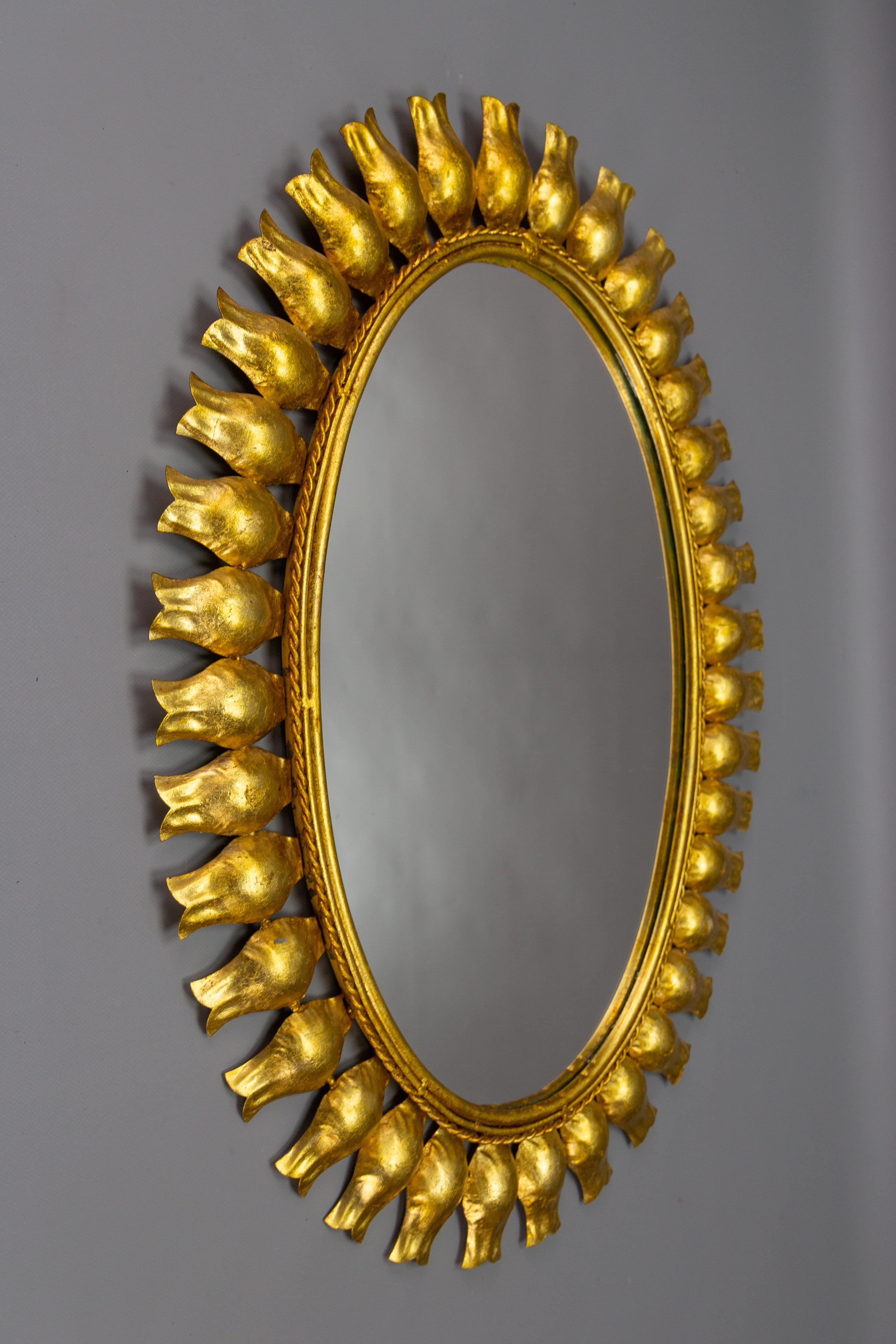 Hollywood Regency Mid-Century Gilt Metal Oval Sunburst Wall Mirror For Sale