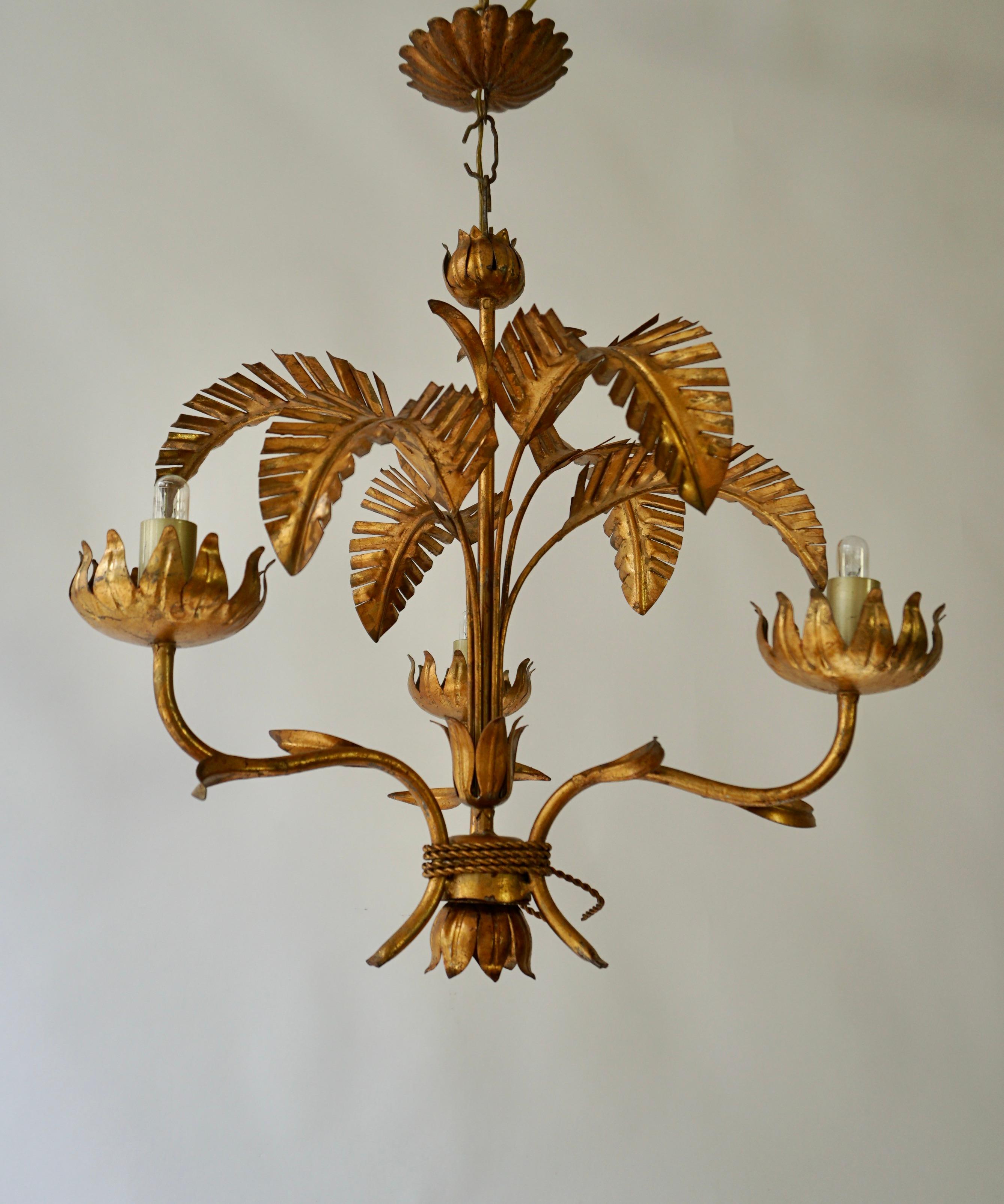 Gorgeous Italian chandeliers in the shape of  palm leaf flowers, made of gilt metal.The chandelier is hand-crafted and in very good vintage and working condition. They can use up to 100W led light E14 bulbs.

Diameter 16.5