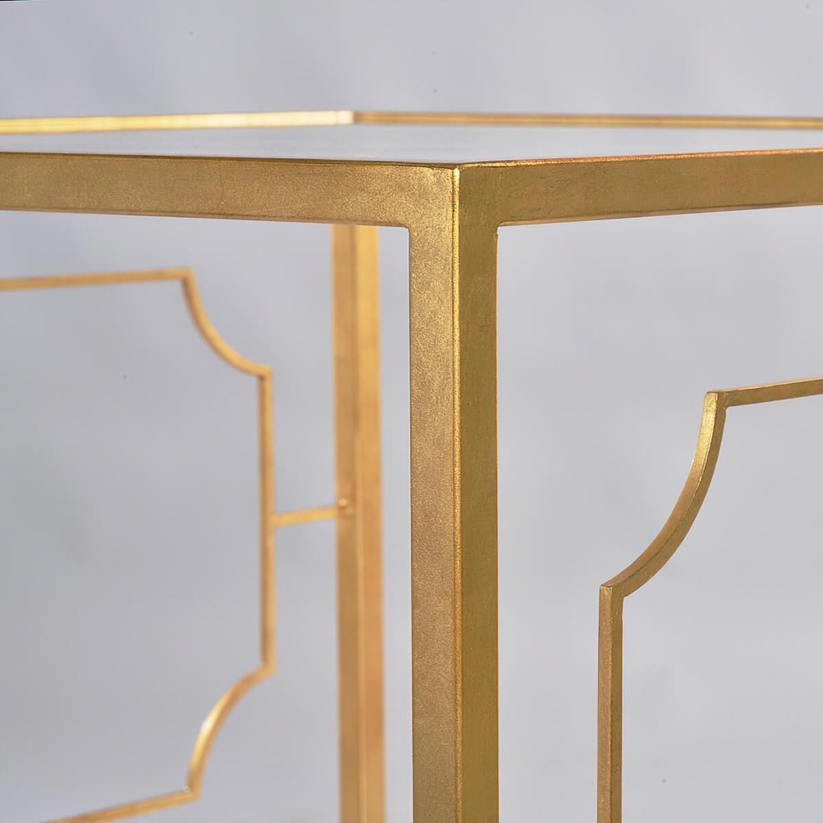 Midcentury square side table with clear tempered glass top and lower shelf, straight legs, and portrait frame detail on the table sides, has a “gold leaf” finish on a steel frame.

Dimensions: 25