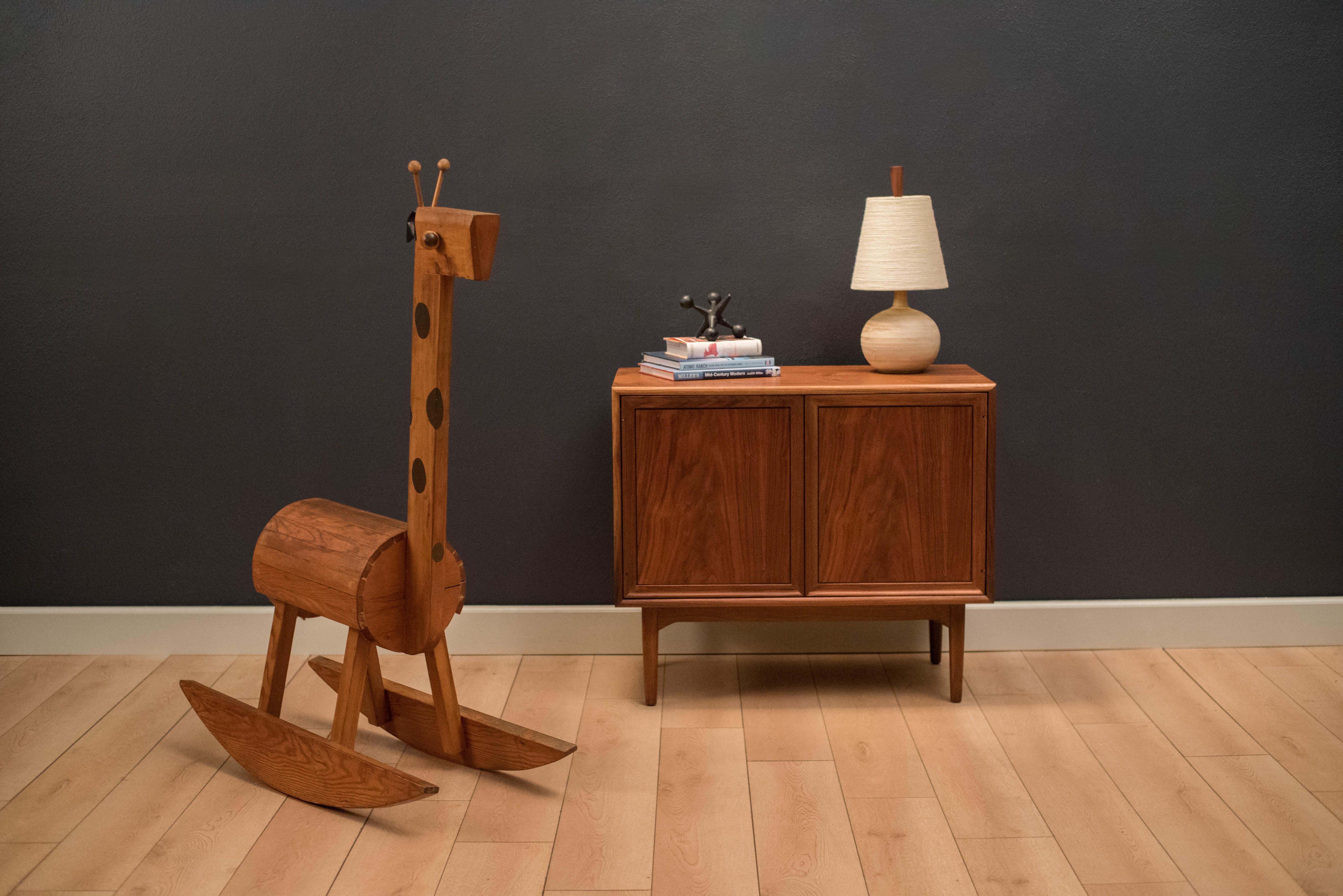 Mid century giraffe rocker toy, circa 1960s. This piece is built with a wooden frame and includes a rope tail with black leatherette ears.


Offered by Mid Century Maddist