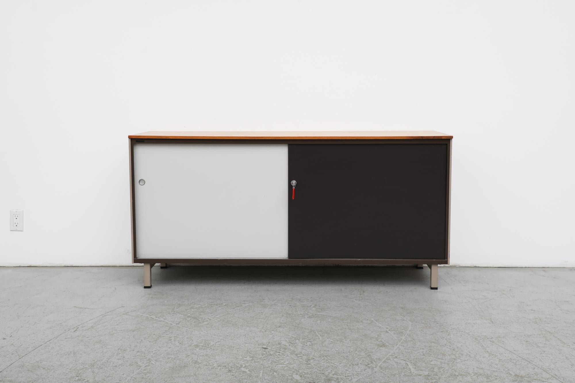 Gispen industrial cabinet or sideboard with wood top and sliding doors. Beige enameled metal frame with grey and black enameled metal sliding doors with round metal inset pulls and can lock. The backs are finished making this piece a perfect room or