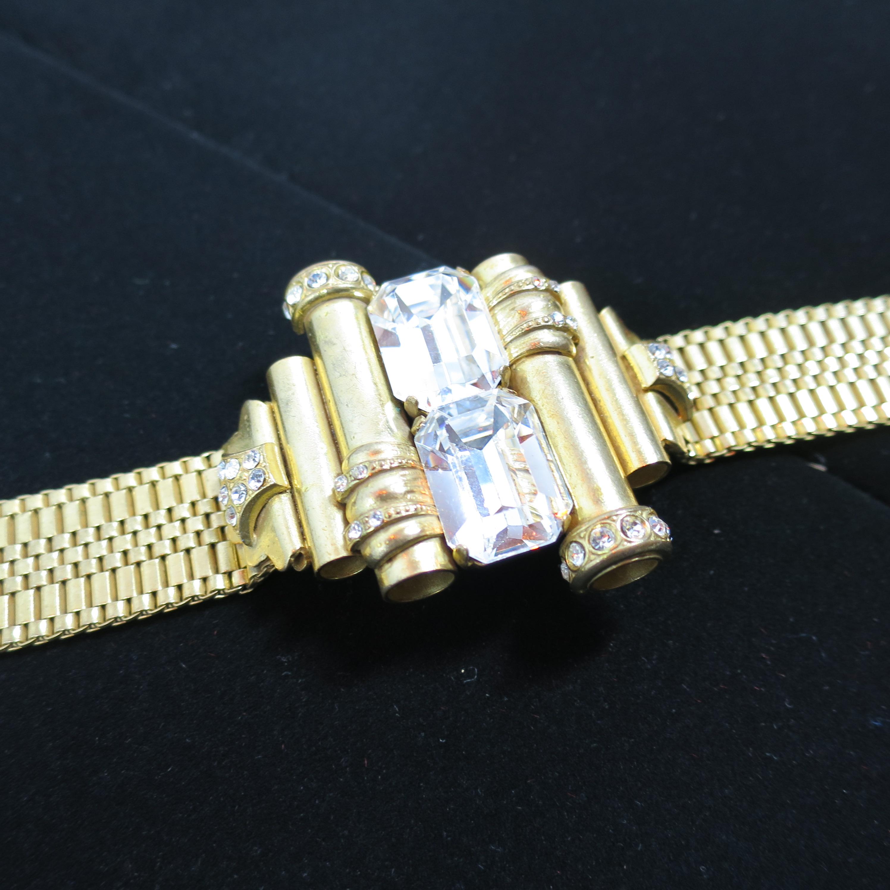 Offered here is a Mid-Century architectural woven-link gold-plated bracelet from the 1940s. The massive centerpiece is slightly curved, and comprised of hollow tubes embellished with pave-set clear crystals; the structural design is a double mirror