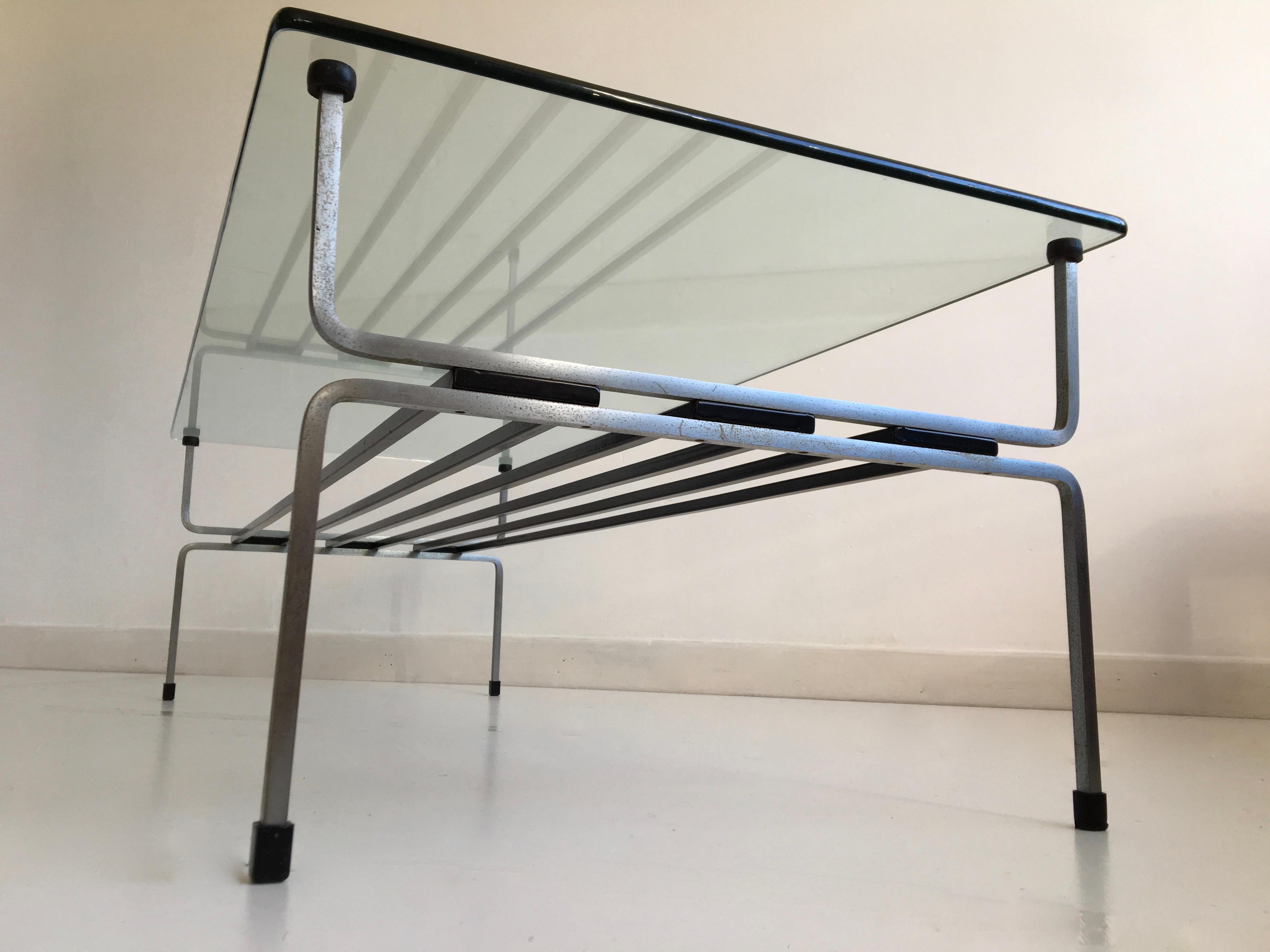 Exquisite steel and glass coffee table by seminal post war English designer William Plunkett.

Dimensions (cm, approximate):
Height 36
Width 112
Depth 48

Condition: There are several scratches to the glass top and a missing plastic foot has