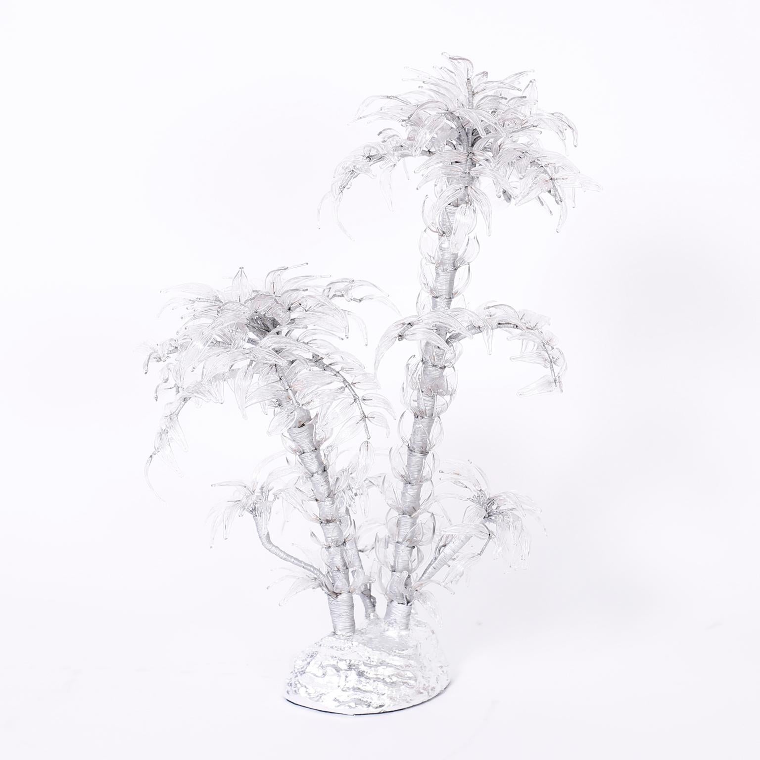 Dramatic mid century palm tree sculpture hand crafted in silvered metal wire with pressed glass leaves presented on a silver leaf base.