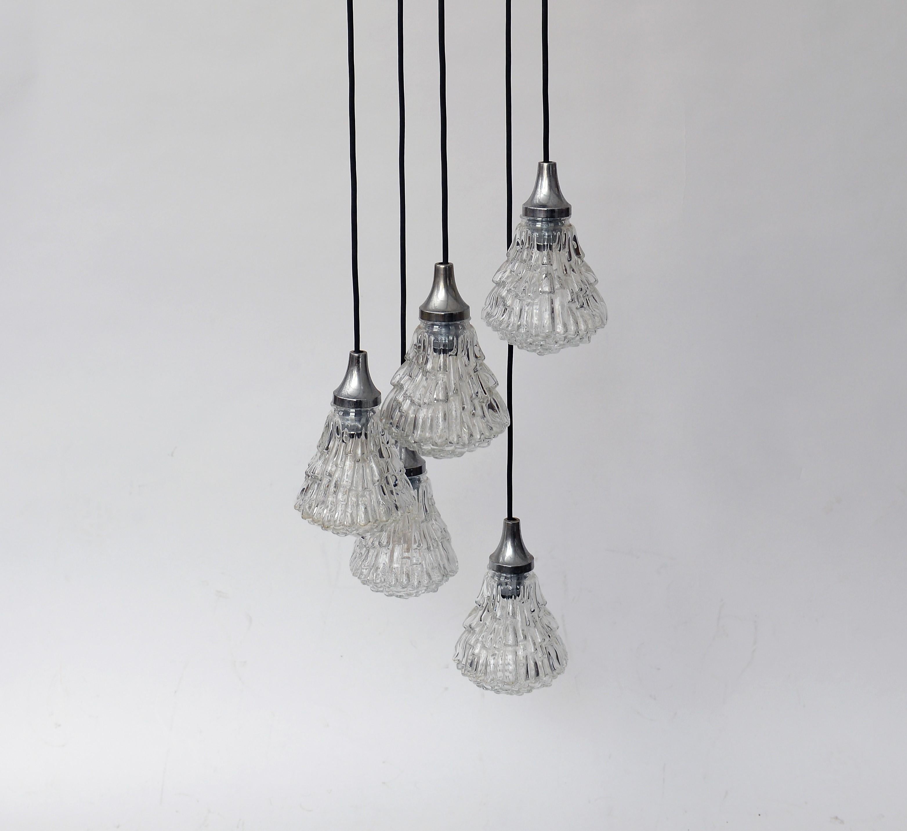 Beautiful 5 lightpoint pendant chandelier.

The chandelier consists of 5 'ice' like glass lamp shades with chrome shade holders.

The lamp emits a beautiful light.

The length is adjustable.

1960s, Germany

Very good condition.

Tested