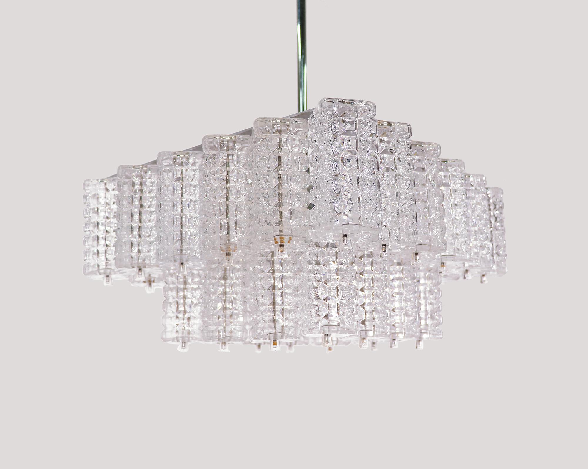 Elegant chandelier with faceted rectangular glass elements on a nickel plated frame with a chromed rod and canopy. Manufactured by Austrolux, Vienna, Austria in the 1960s. 

Measures: w 16