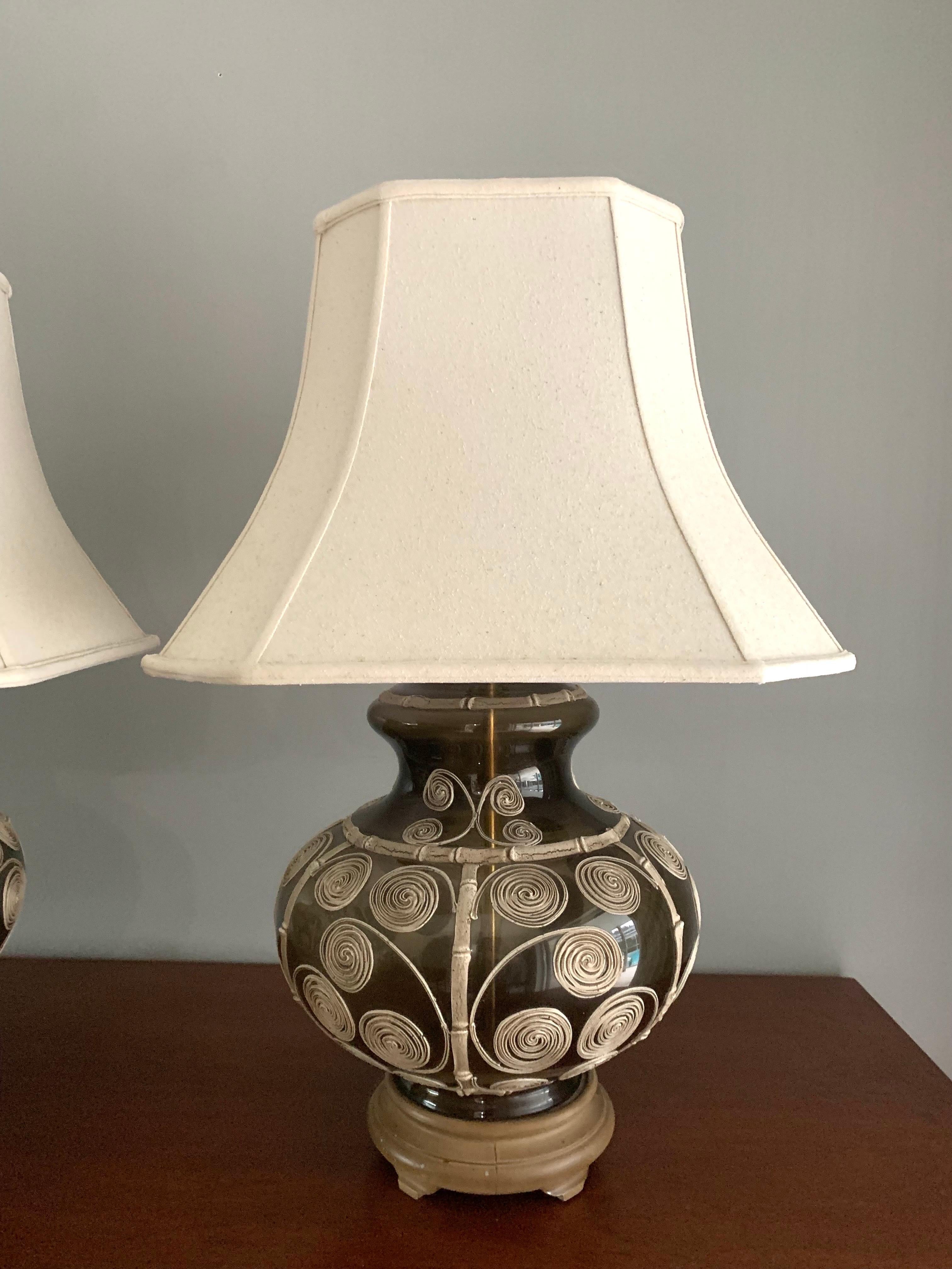 Pair of greenish brown glass ginger jar form lamps with beautifully detailed faux bamboo ceramic accents. 

Hand crafted patterns create a beautiful contrast on the glass and add great dimensions to the lamps. 

Both lamps are in working
