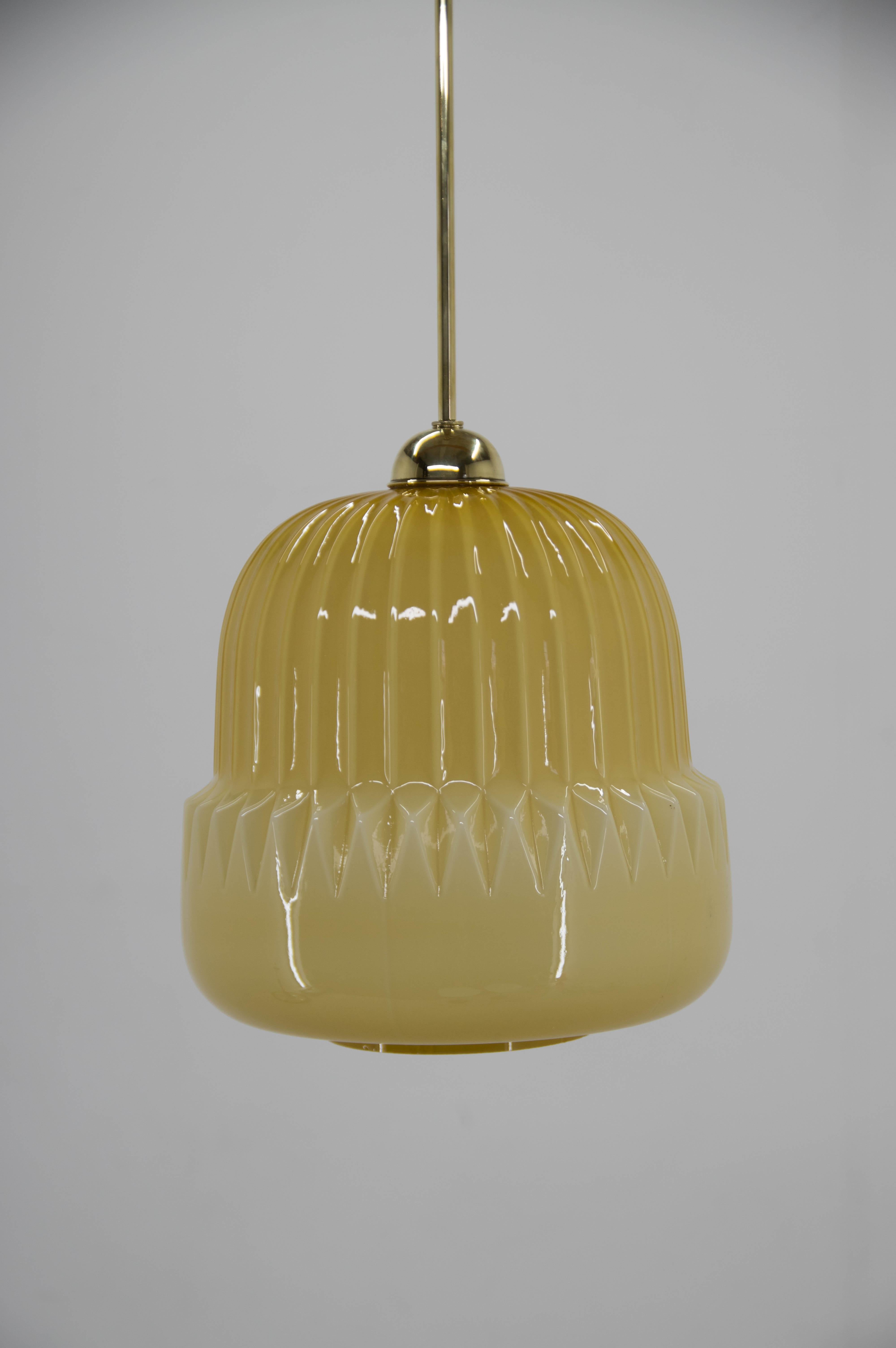 Dark yellow midcentury pendant made of glass and brass.
Glass in good condition with one little chip on bottom visible on picture.
Central rod can be shorten on request.
Rewired: 1x100W, E25-E27 bulb
US wiring compatible.