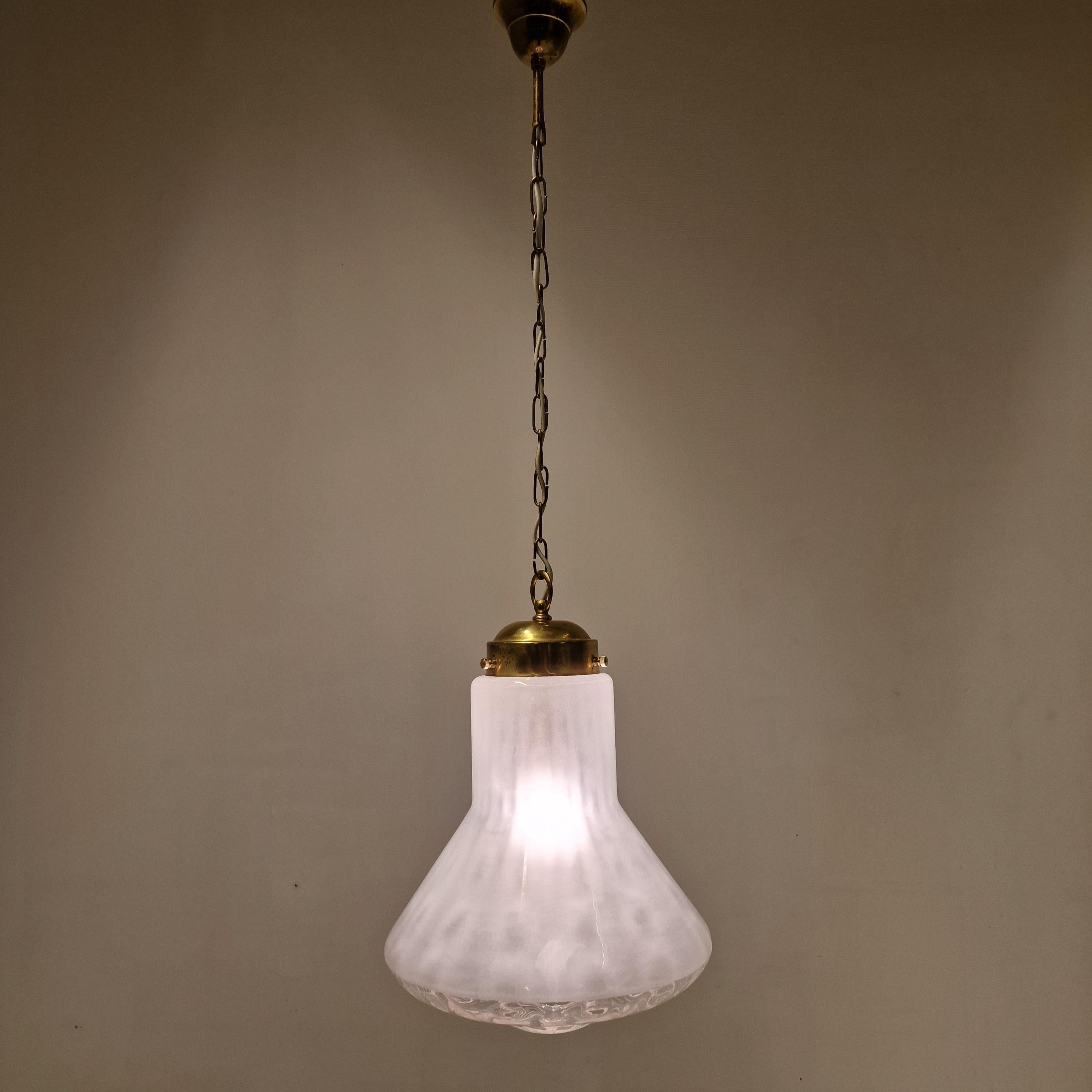 Very nice pendant fabricated in Italy in the 70's.

The lamp shows true craftsmanship. 
Beautiful hand blown glass bulb in white and transparent. 

Very good vintage condition, no cracks or chips. 
The wiring is suitable for all countries around the