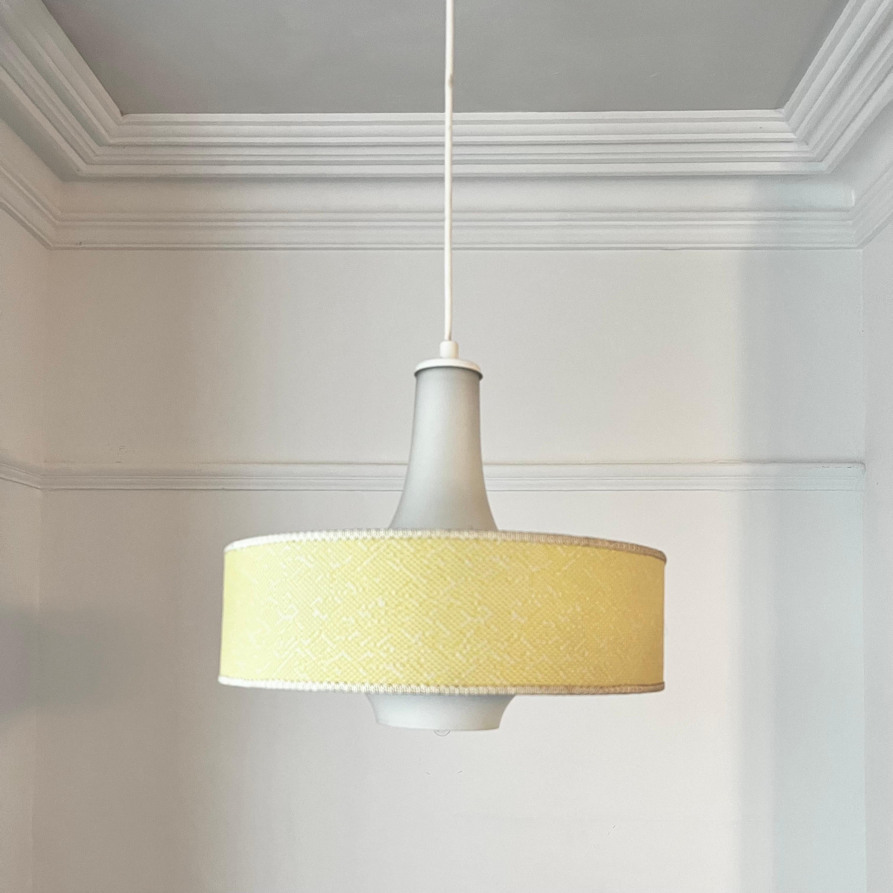 A simple glass pendant light, with an optional lemon-yellow outer shade by Itsu or Finland. Mid-20th century. Labelled. A similar model shown in the Itsu catalogue dated 1963.

The light is made up of an onion-shaped glass body, which carries a