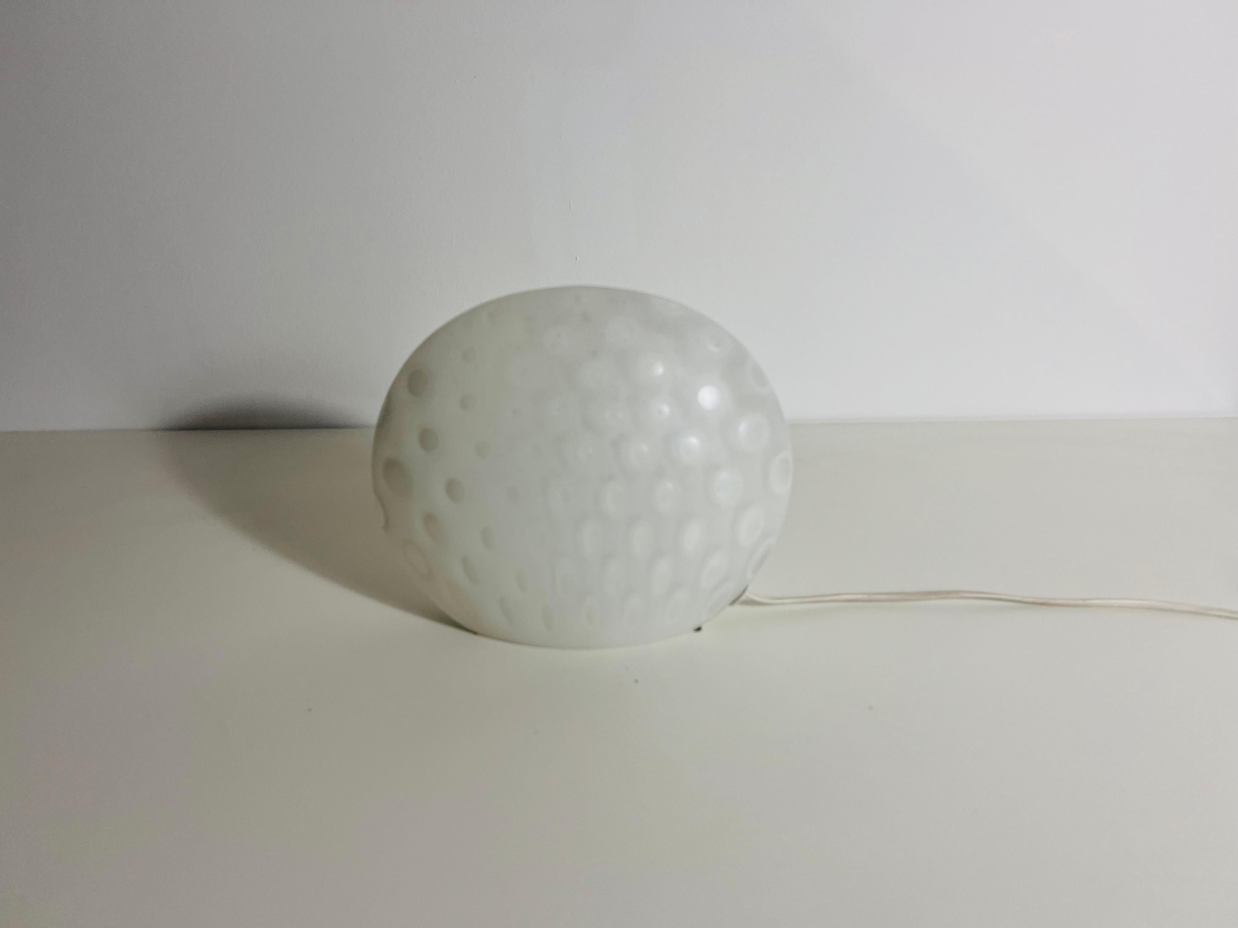 This stunning table lamp, crafted by Peill & Putzler in Germany during the 1970s, is a true example of timeless design. Made from high-quality opal glass, it features a distinctive shell-like shape, which sets it apart as a unique decorative piece.
