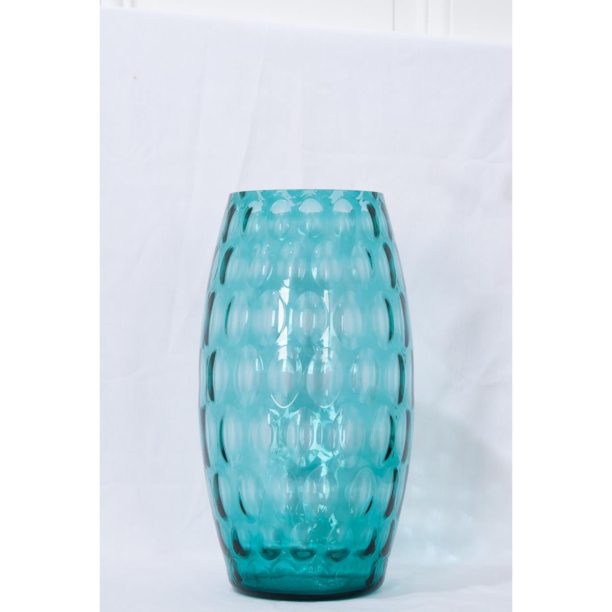 Lovely, aqua-blue glass vase, circa 1960. The oval concave shapes imposed on its interior provide a light texture to the vase’s exterior and compliments the convex shape of the vase.