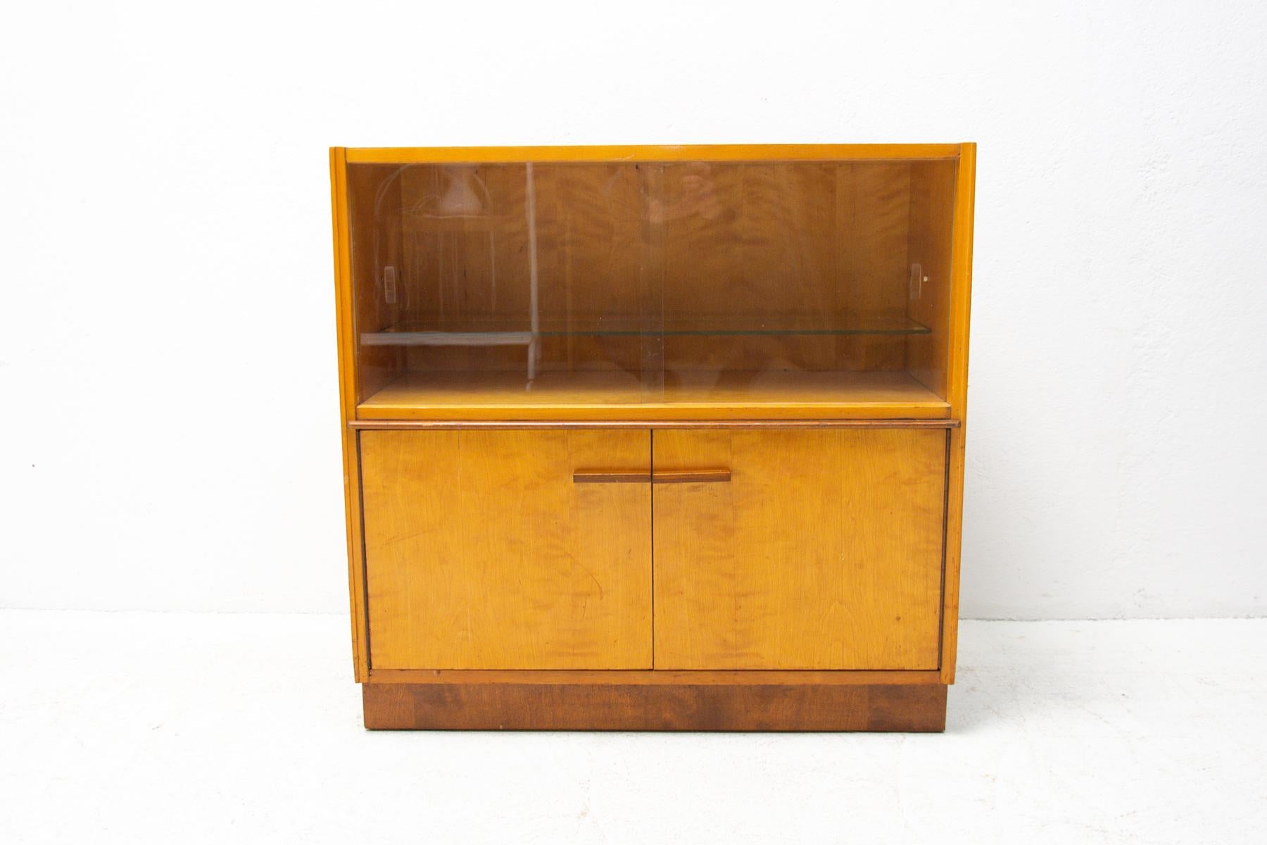 Multi-purpose glazed cabinet, made for ÚP Závody in the 1960s. Made in a combination of ash, elm, maple, walnut, birch and poplar wood. Glazed upper part. It´s in good Vintage condition, shows slight signs of age and using.
 