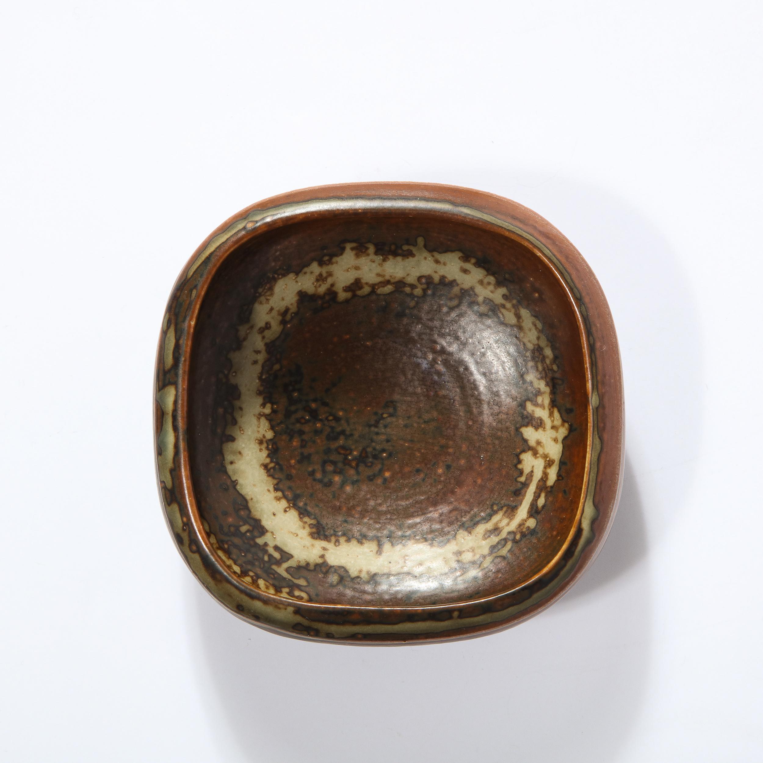 This gorgeous stoneware bowl in shades of brown, taupe and umber is hand wrought by Bode Willumsen for Royal Copenhagen wonderful hand glazed textural organic pattern. This piece is signed Royal Copenhagen, Denmark and numbered as well. A great