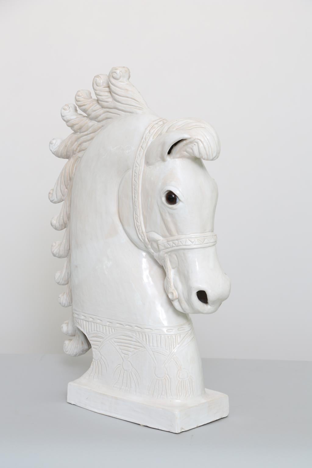 Horse head sculpture, with midcentury, stylized details, and glass eyes. Possibly made as an incense burner due to the chimney hole at the top of its mane. 

Stock ID: D2758.