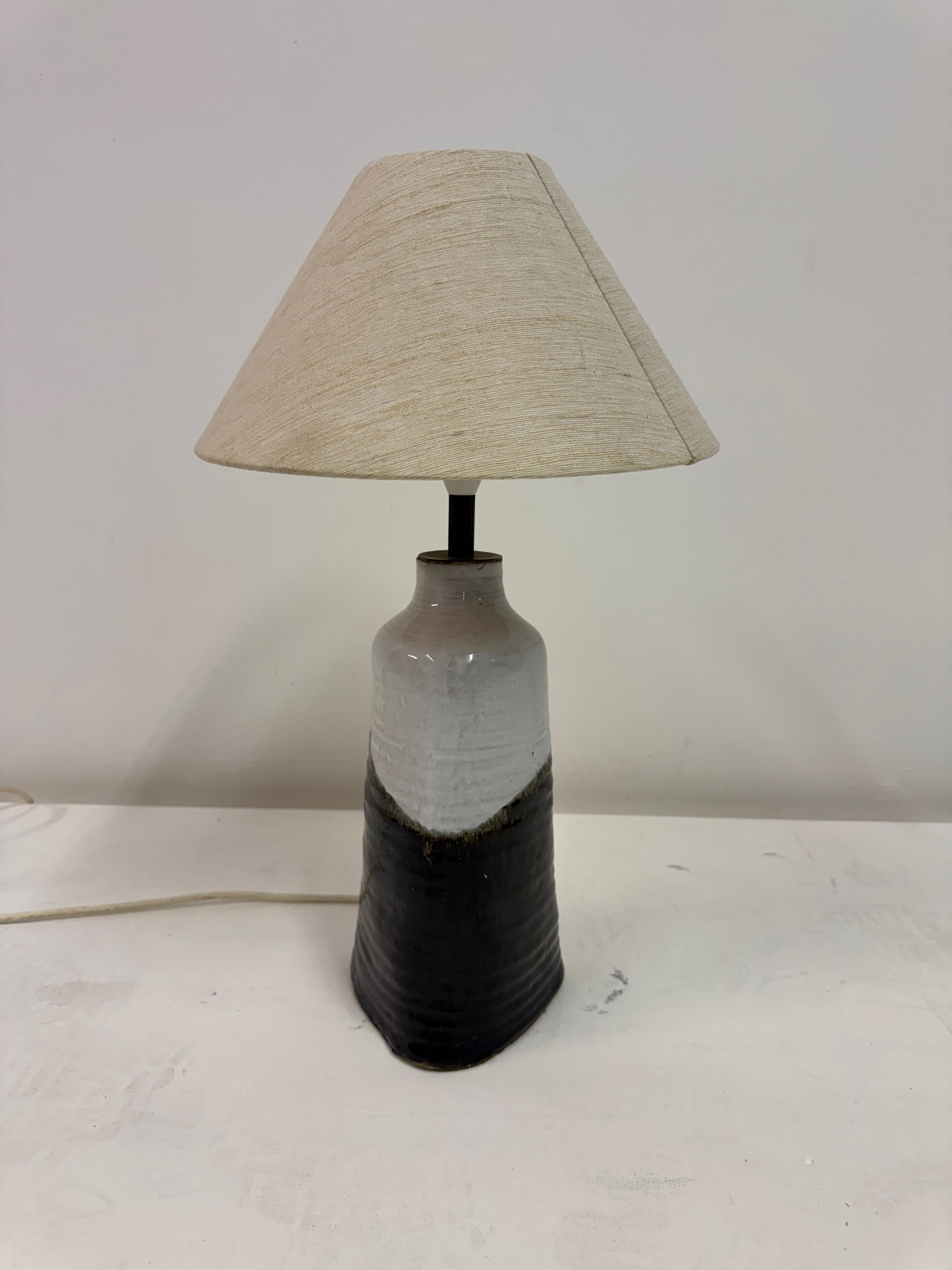 Mid-Century Glazed Pottery Table Lamp, 1960s

A quietly sculptural table lamp in glazed stoneware, likely European, dating to the 1960s. The form is gently tapering, with hand-thrown irregularities that speak to its studio origins. Its glaze moves