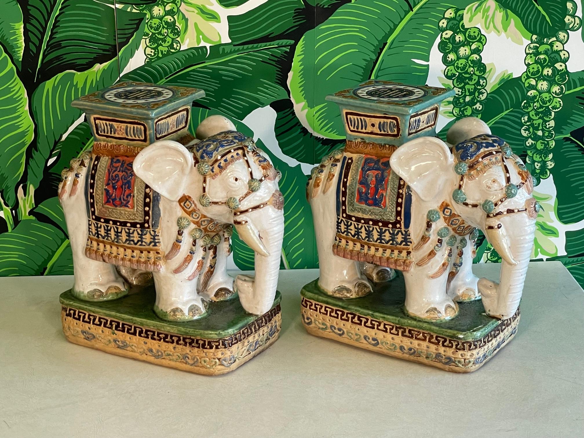 Pair of midcentury glazed terracotta elephant garden footstools / seats / stands a white glossy finish with accenting colors. Very good condition. As with all our vintage items, may exhibit scuffs, marks, or wear, see photos for details. 

