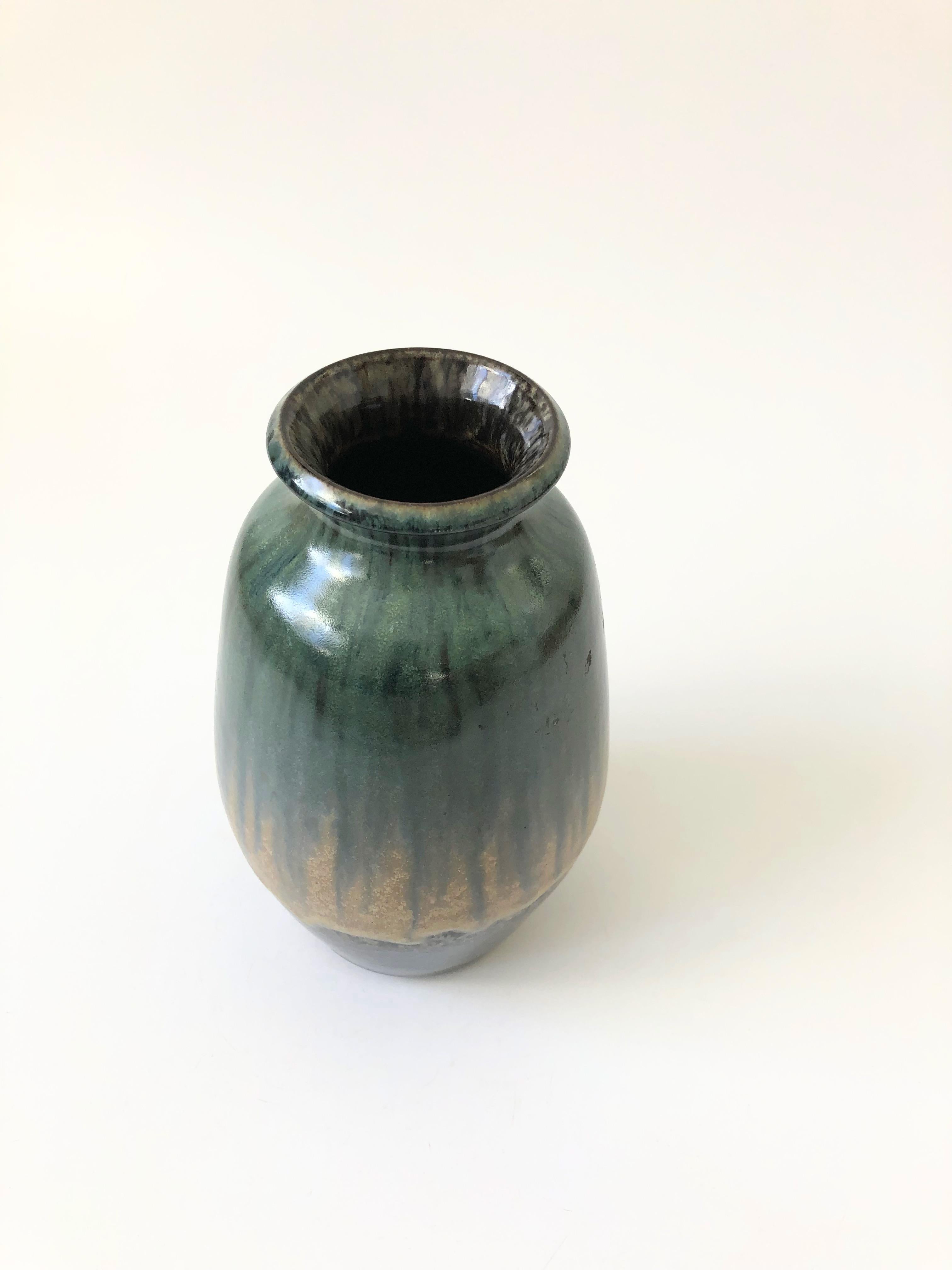 A beautiful mid-century Icelandic lava pottery vase. Beautiful earthy muted green drip glaze. Made in Iceland by Glit HF. The original sticker is attached to the bottom.
 