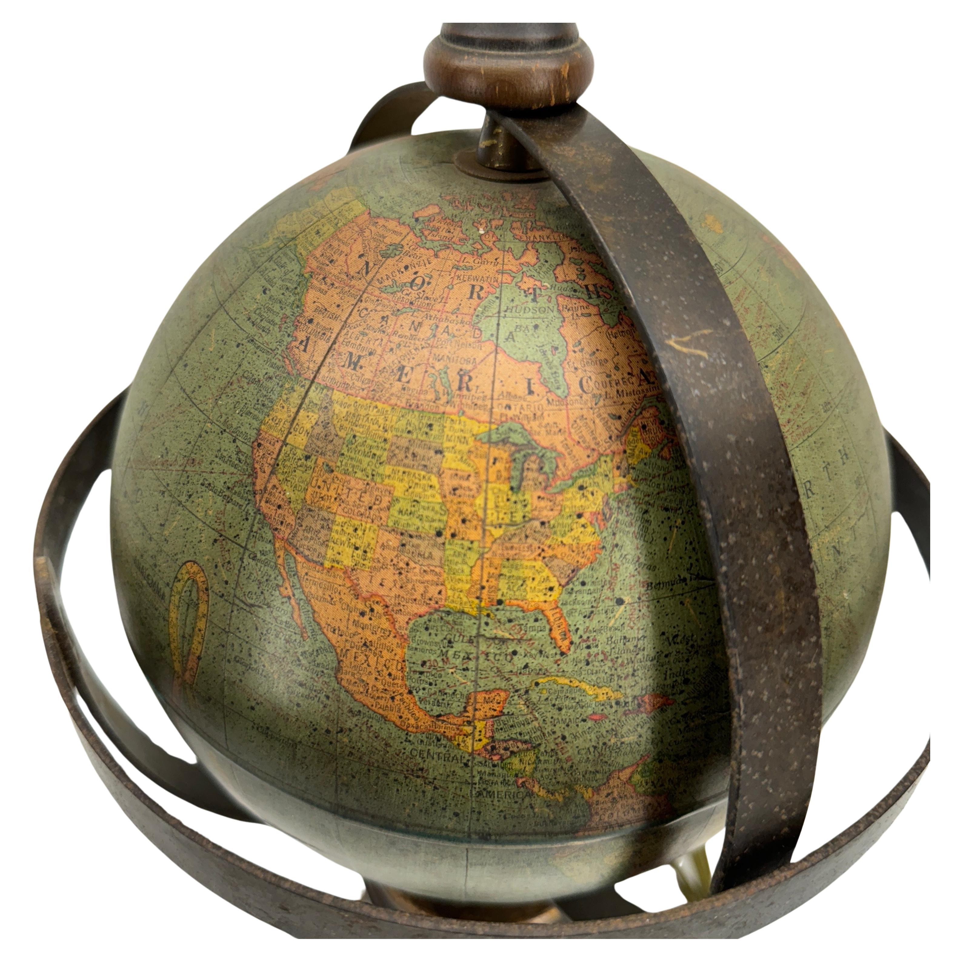 Old World Globe Table Lamp, 1950's

Impressive 8 inch Terrestrial Globe made by George F Cram Company Indianapolis, Indiana. This classic Mid-Century Modern lamp would be a wonderful addition to any library, study or bedroom setting. 
The base