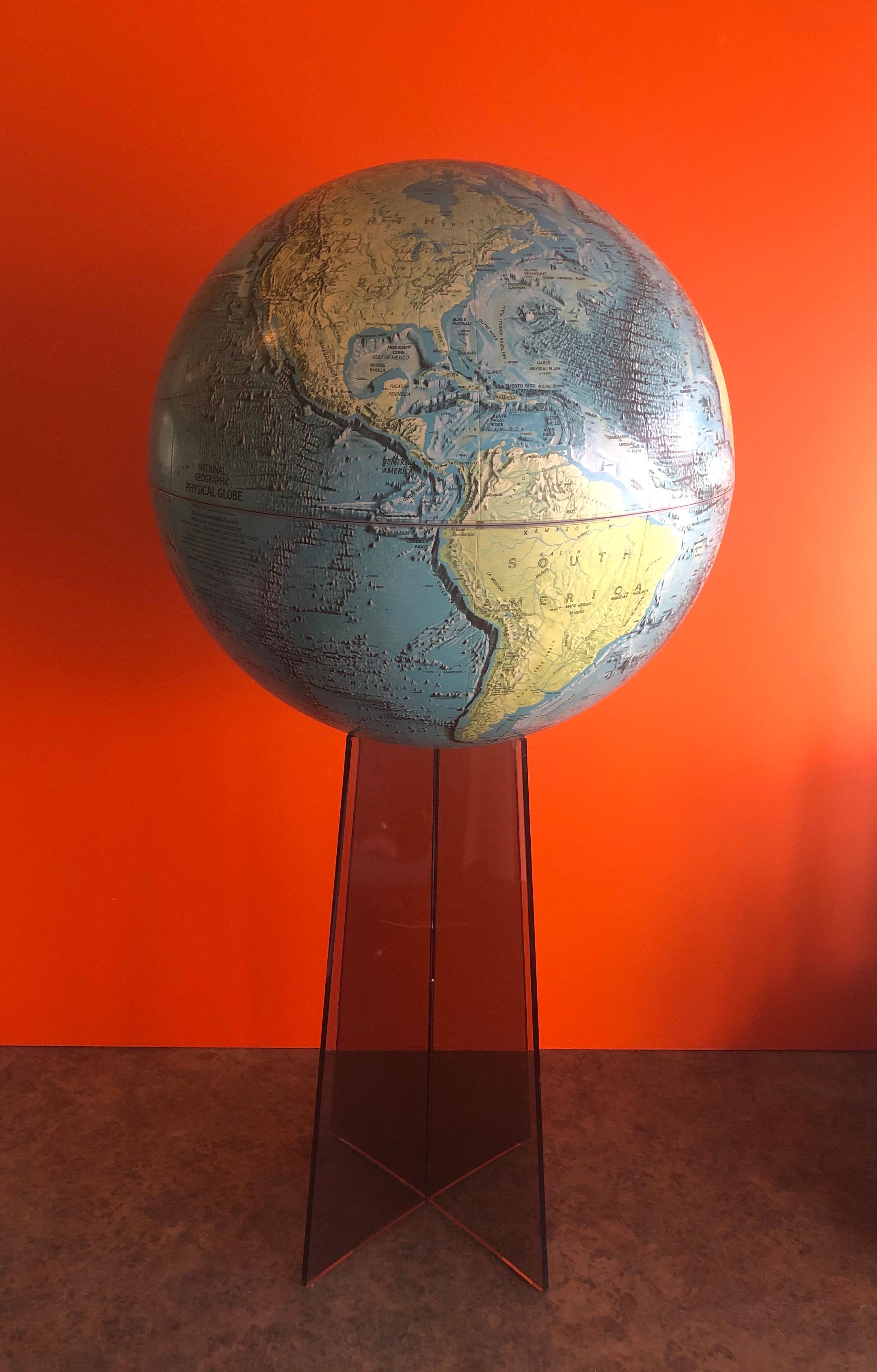 Large midcentury globe on smoked Lucite stand by National Geographic, circa 1970s. This a very cool piece with removable and super colorful 16