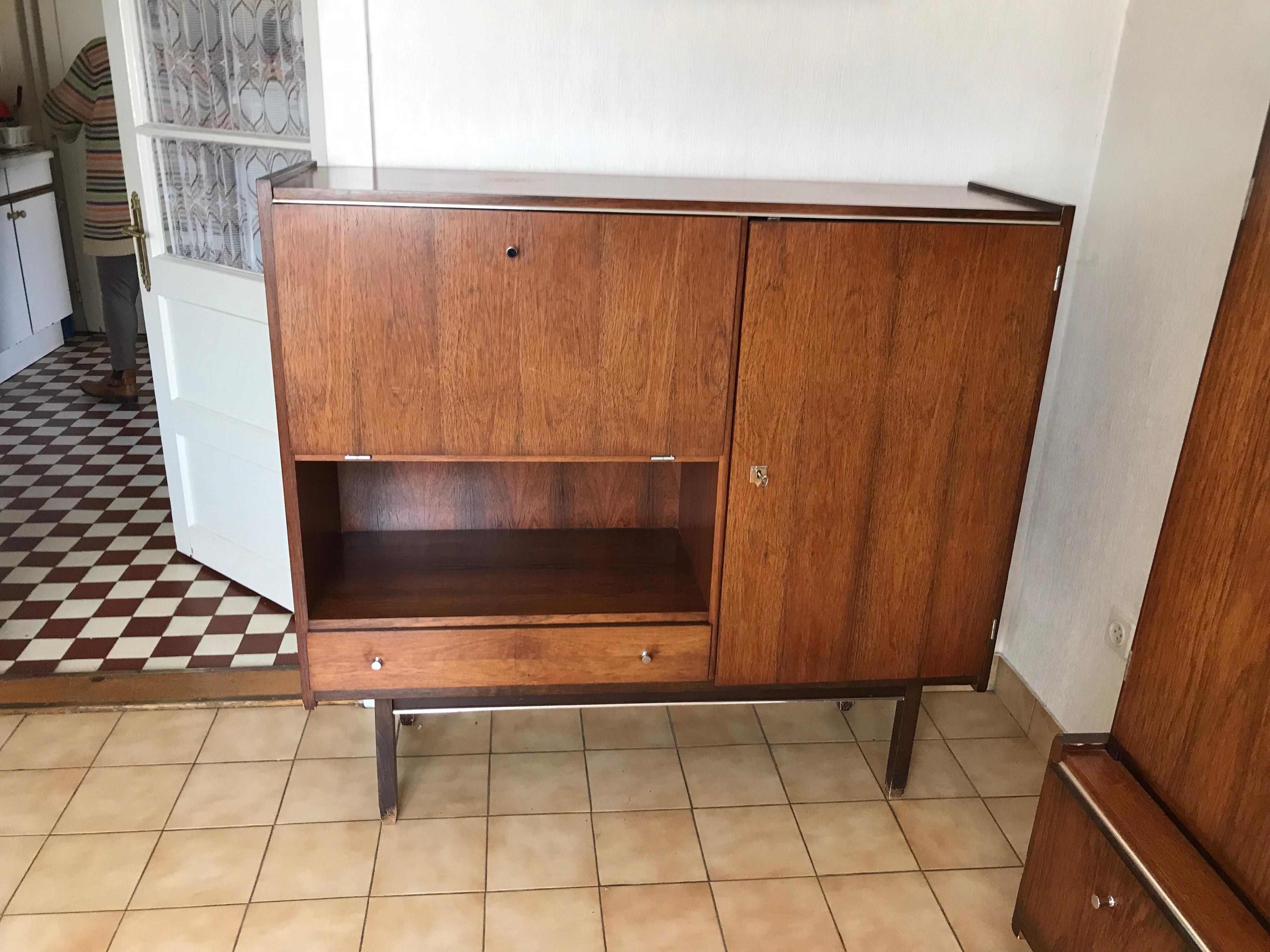 Midcentury G.N.B cabinet 1960s.
Original good condition.
Size: 130 x 40 x 119 H
This is a complete set
1 cabinet is small
1 larger cabinet
1 table and 6 chairs.
 