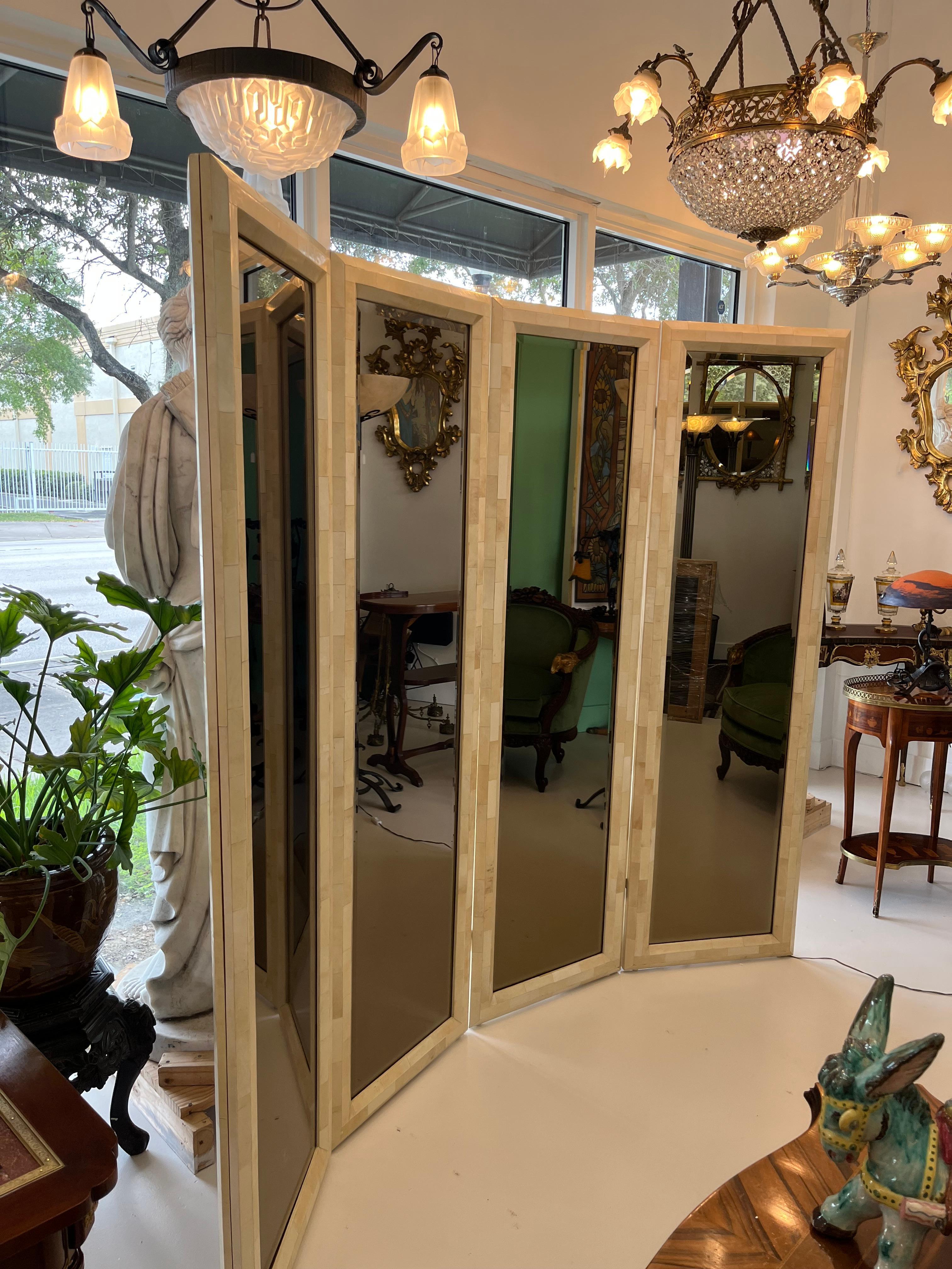 Really amazing Mirrored room divider attribute to Karl Springer with 4 panels with Goatskin parchment and its original beveled mirrors , one side regular mirrors and the other side mercury treatment mirrors giving to this piece an incredible touch