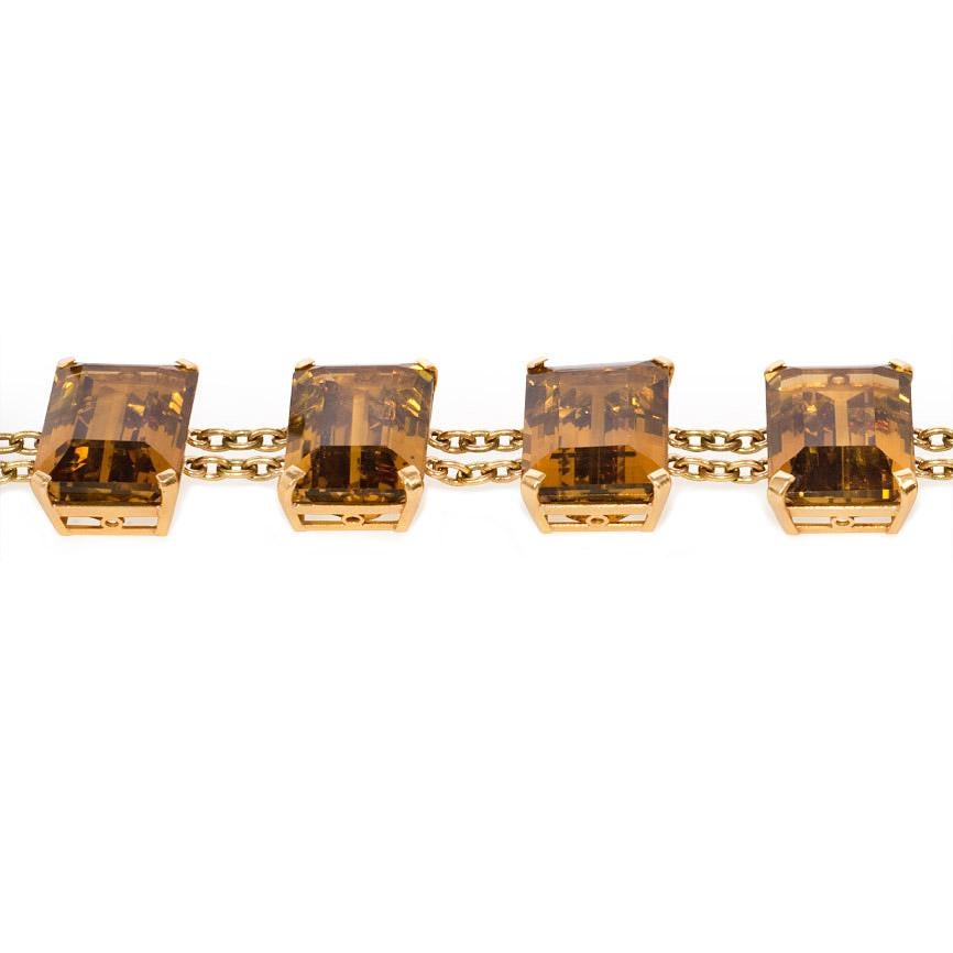 A gold and citrine bracelet featuring faceted rectangular citrines joined by two rows of gold chains, in 18k with spring ring clasp.  Approximately 142-150 carats