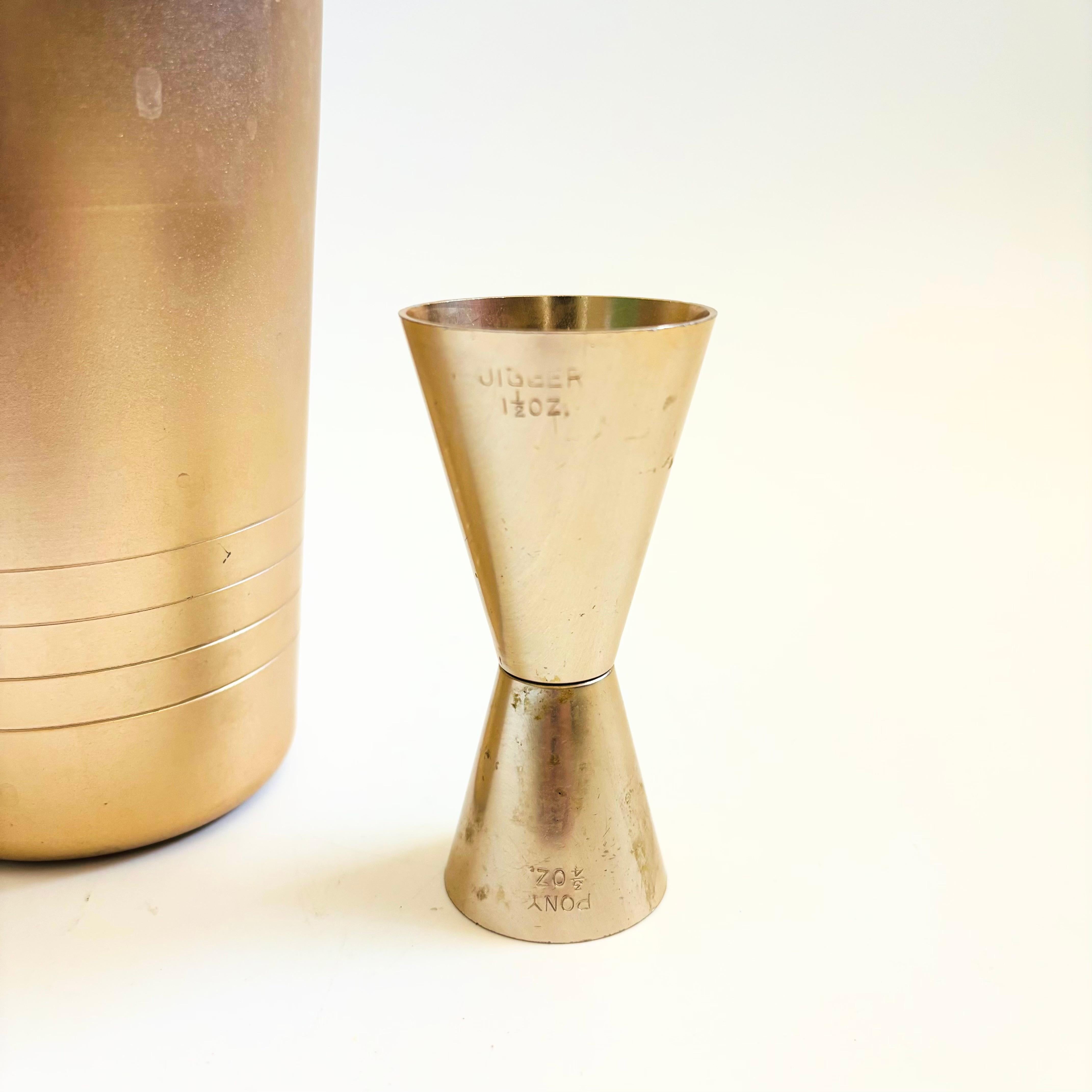 Mid-Century Modern Mid Century Gold Cocktail Shaker and Jigger by Mirro For Sale