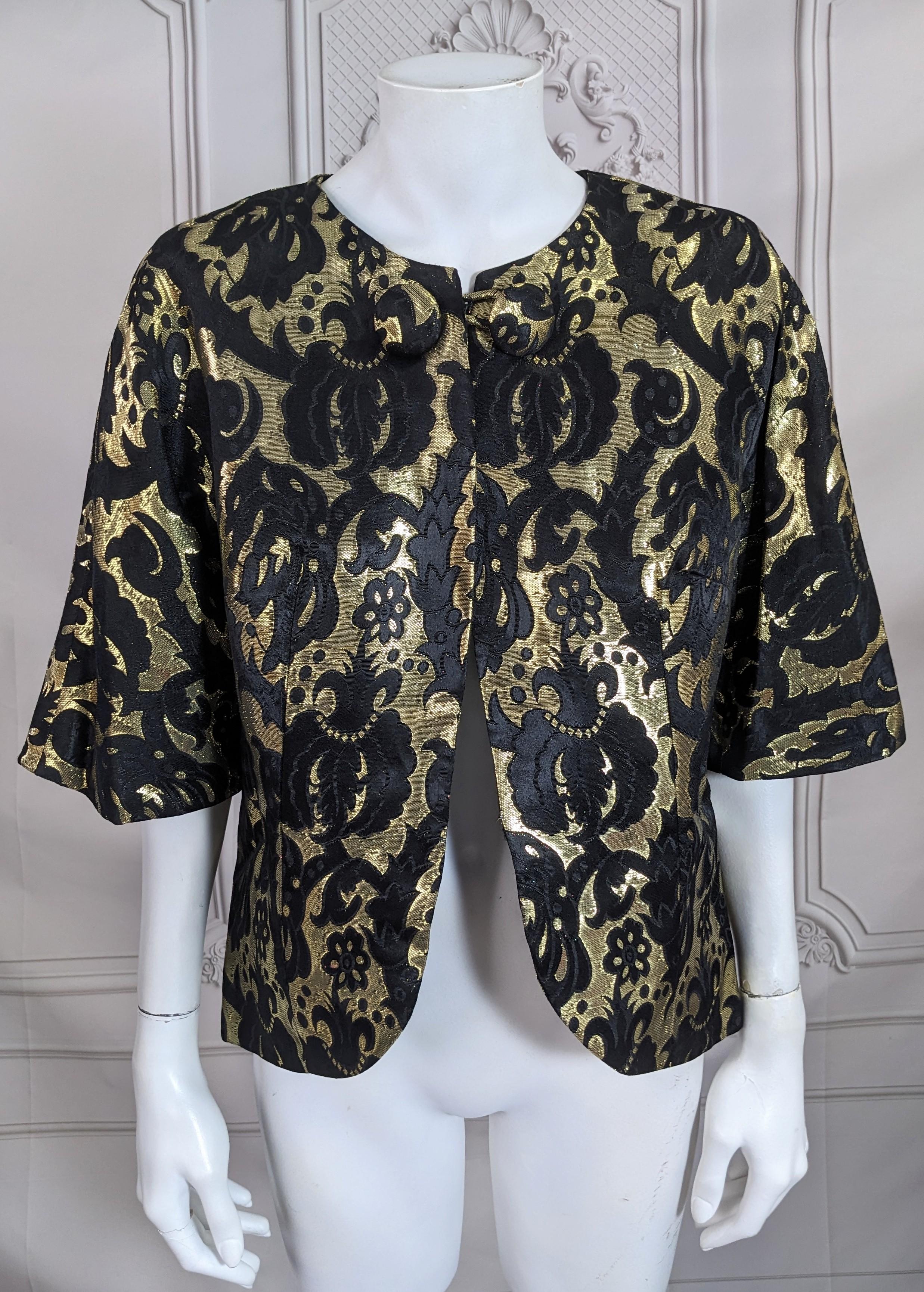 Gold Metallic Brocade Jacket from the 1960's. 2 covered buttons at neck which act as closure with 3/4 sleeves and easy cut. Retailed by Saks Fifth Ave, 1960's. Fits as Medium. Great as an evening or even day separate. 