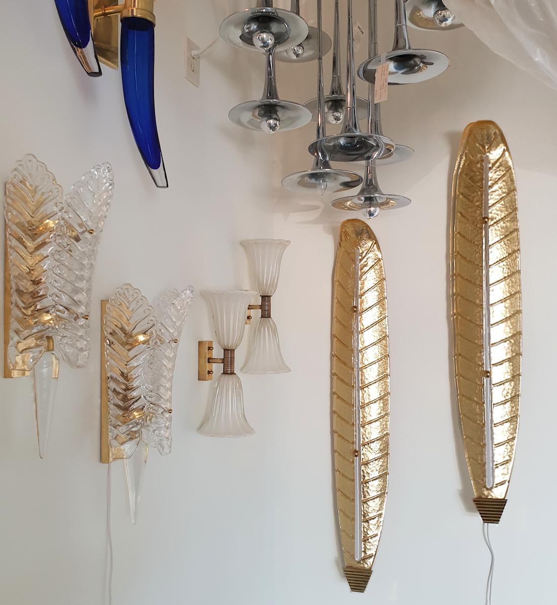 Pair of Mid-Century Modern, very tall and thin Murano glass leaf shaped sconces, Barovier & Toso style, Italy 1970s.
The neoclassical sconces are impressive by their dimensions and quality!
The vintage Murano sconces are made of real 24 carats gold