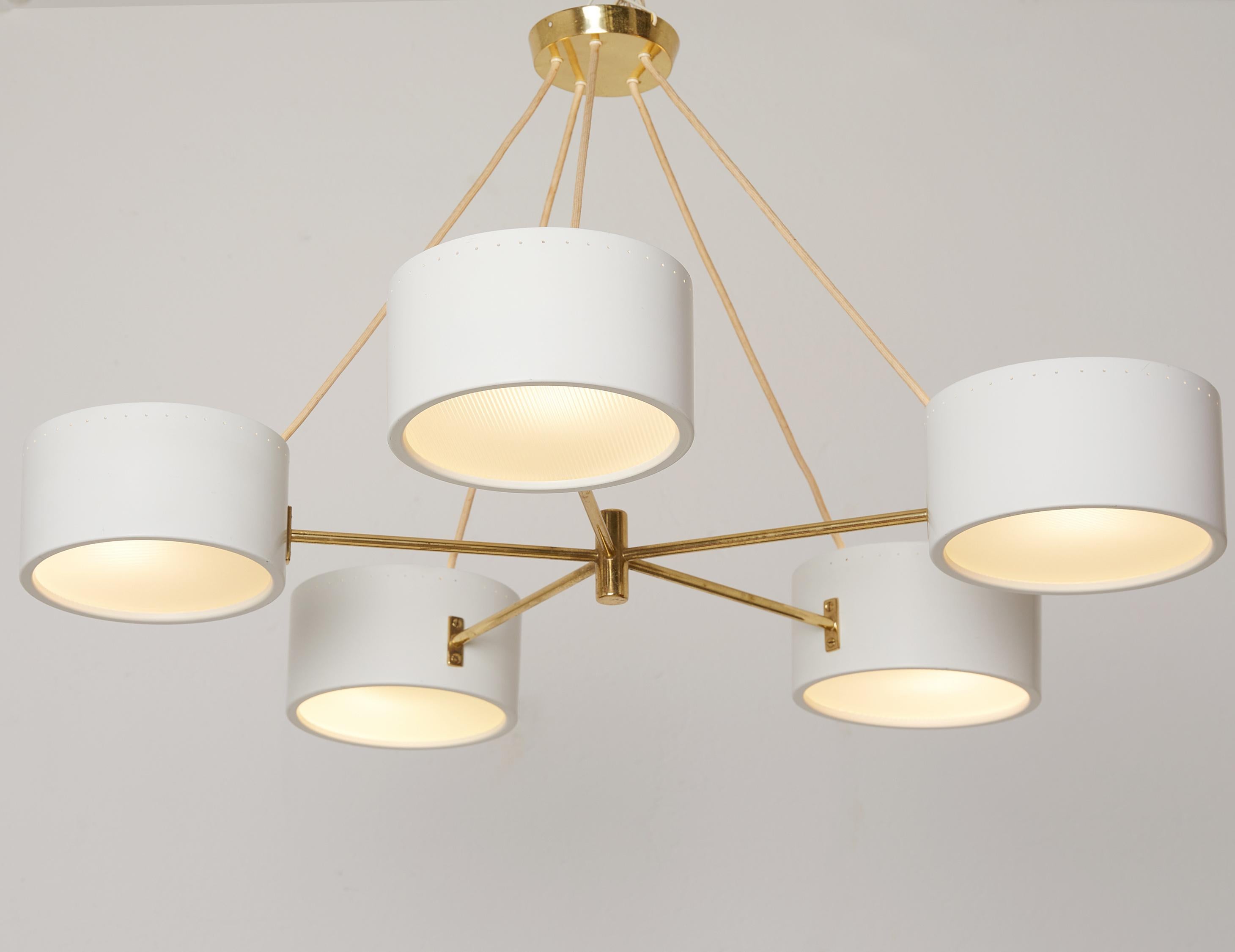 Mid-century gold plated brass chandelier by BAG Turgi Switzerland around 1950

Circular structure with five arms in massive gold plated brass. 
Five circular white lacquered reflectors with frosted and embossed glass lens diffusers which produce