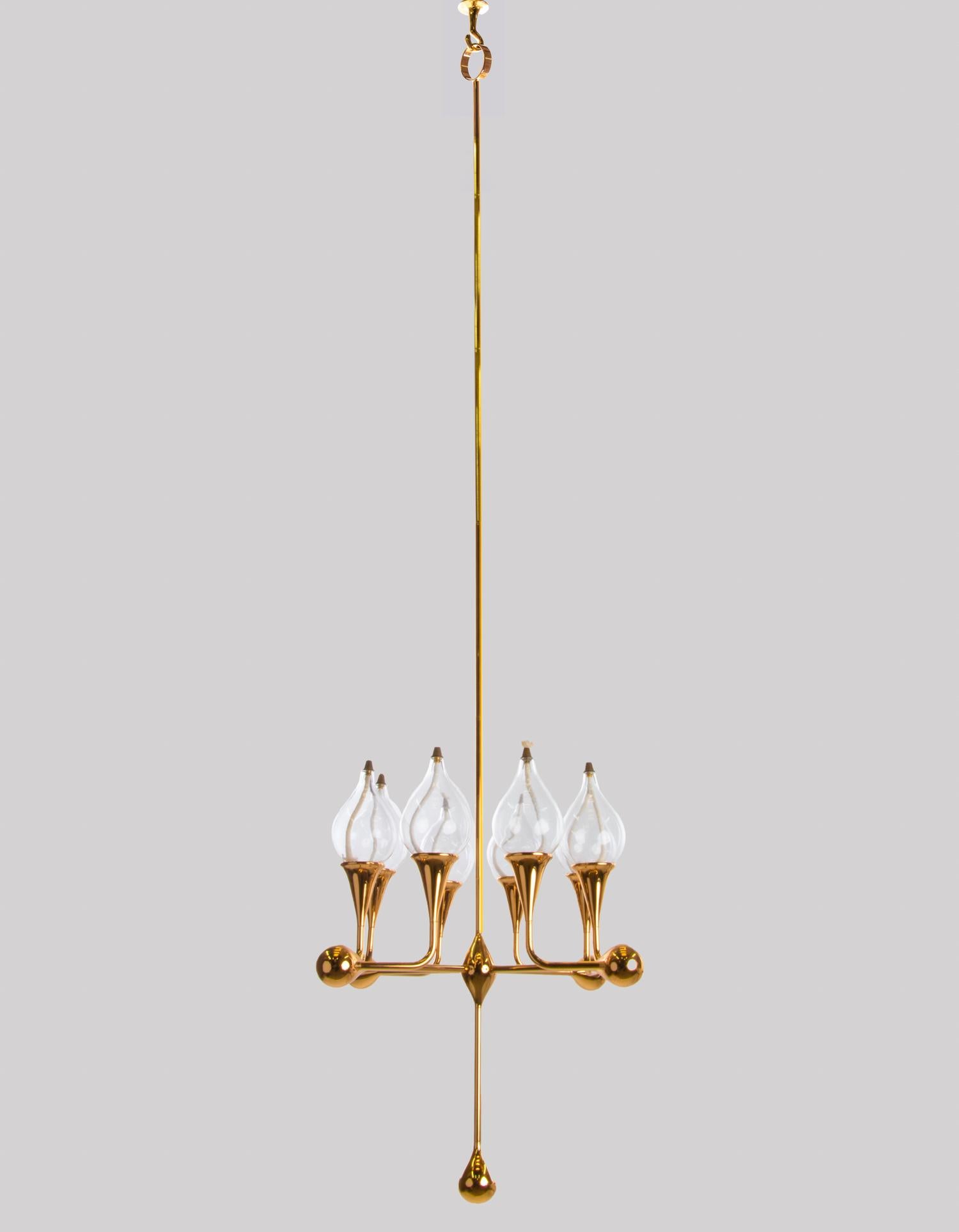 Mid-century hand made and gold plated oil candelabra with 8 teardrop shaped glass candles. Manufactured in Germany in the 1970s. 

Design: Freddie Andersen. 
Measures: H 52