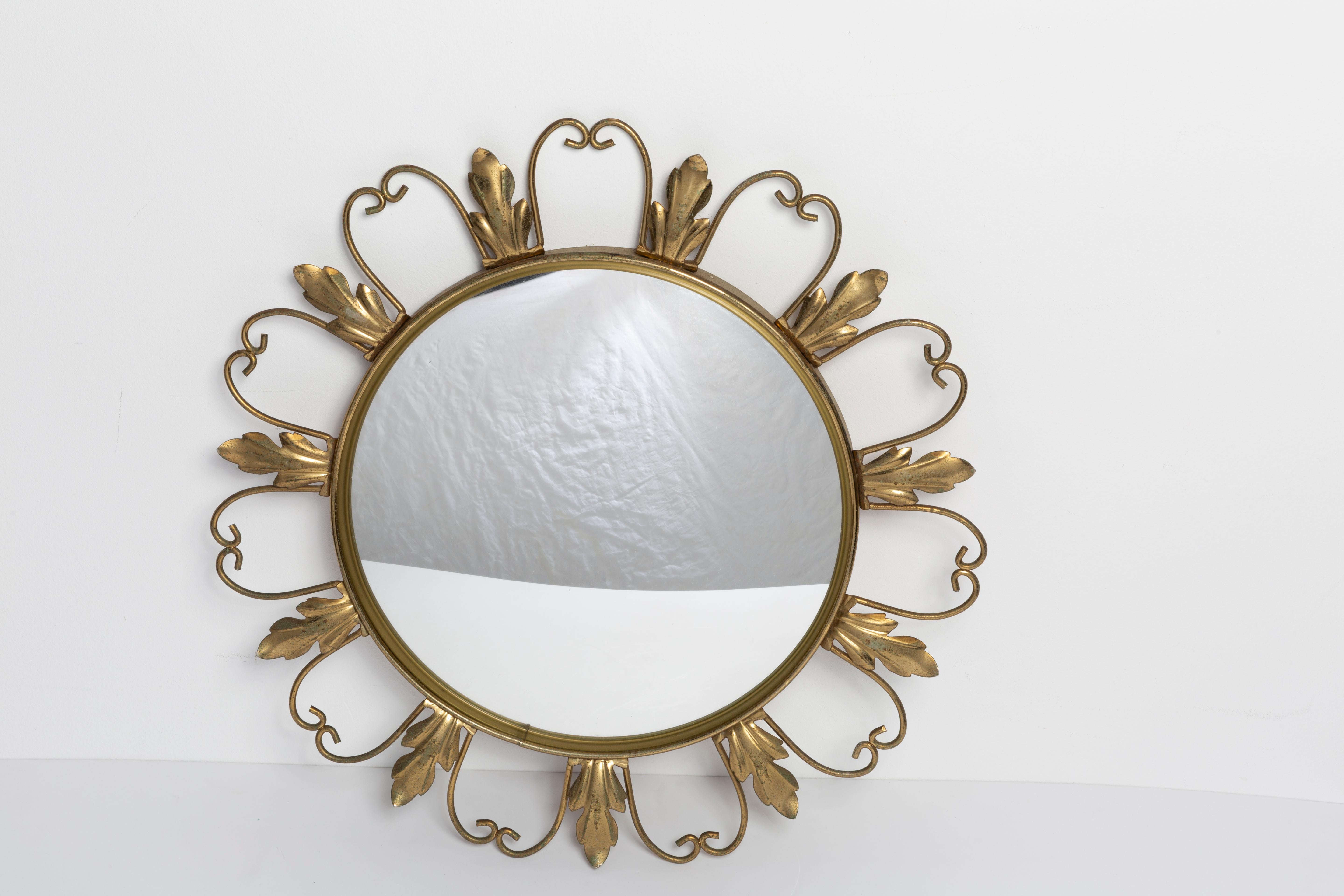A mirror in a golden decorative sun-shaped frame from Belgium. The frame is made of metal and wood. Very good condition. Beautiful piece for every interior! Signed 