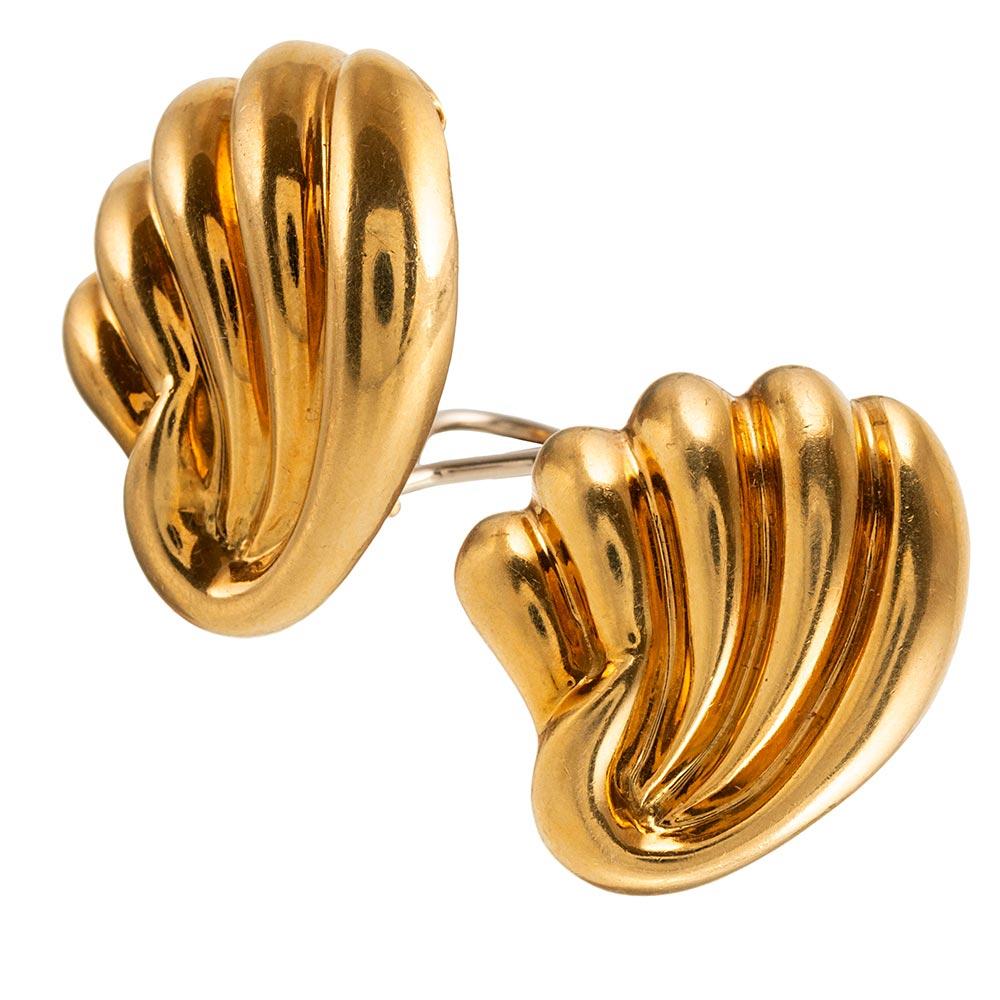 Swirling strokes of 18 karat yellow gold are fashioned into a wing-like or shell design. The earrings are simply charming, with equal parts sophistication and whimsy. They measure approximately 1 inch square and are currently clips, however a post