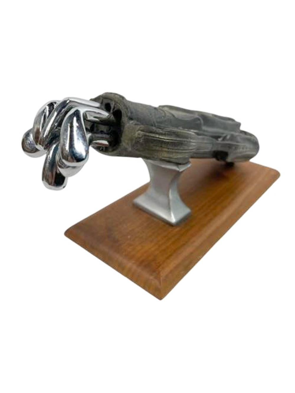 Mid twentieth century set of six chromed golf club form cocktail stirrers / muddlers held in a bronze golf bag set at an angle on a wooden base. Stirrers about 6