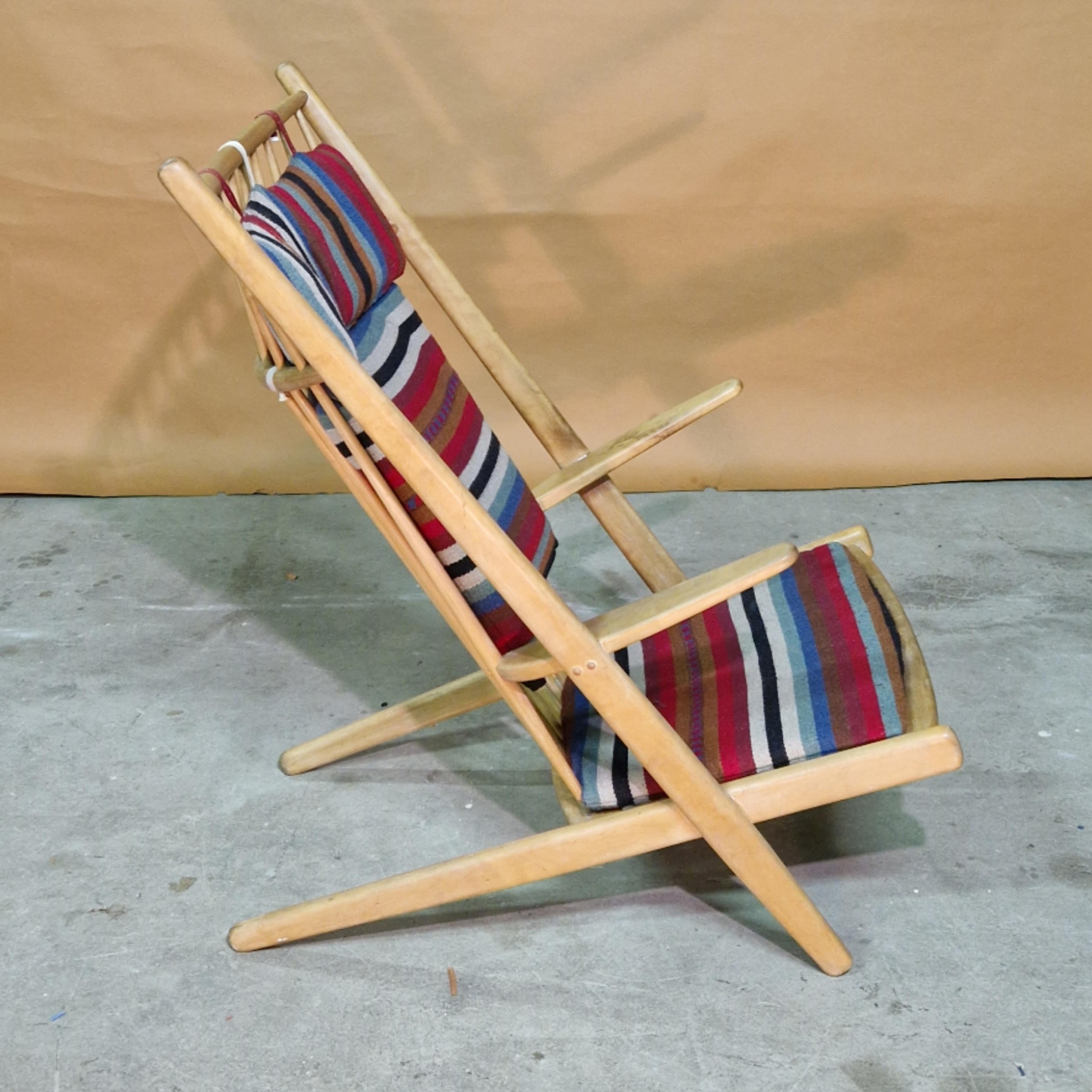 Iconic Goliat lounge chair designed by Paul Volther for Gemla in the 1950s. Made from wood with metal coil spring seat and wood spindle back. It is upholstered in multicolored Bohemian style fabric. 

