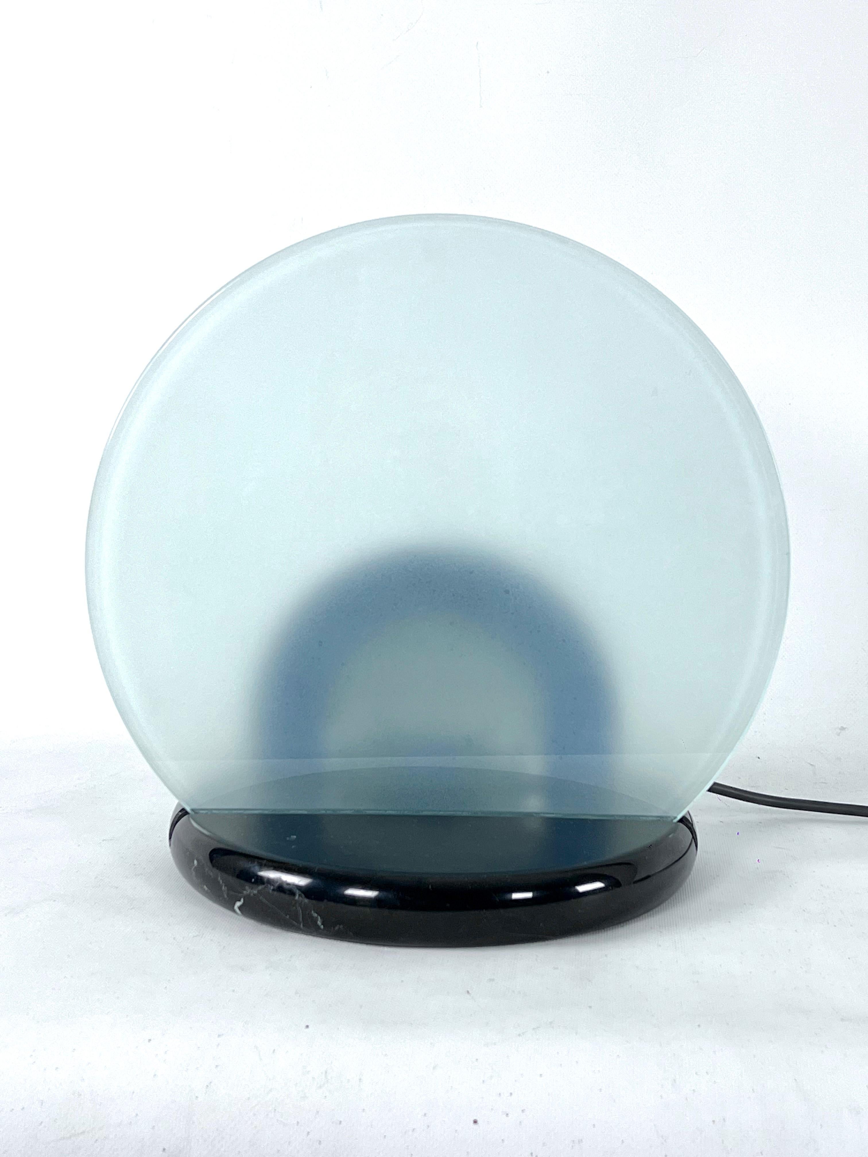 Great Vintage condition with a normal trace of age and use for this table lamp model Gong designed by Bruno Gecchelin for Skipper an produced in Italy in 1981. Made from black marble base and thick sanded glass. Full working with EU standard,