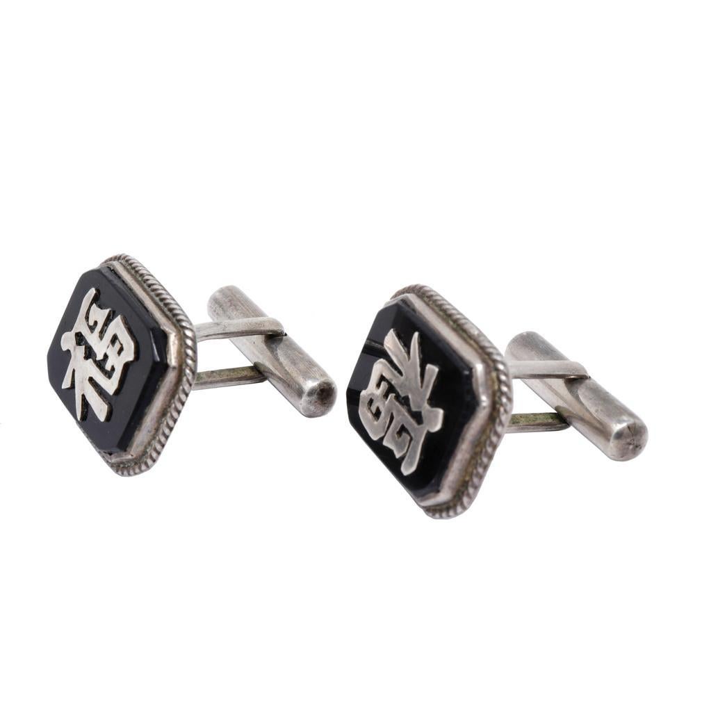 Mid-century Good Luck Cufflinks. Crafted in Hong Kong from sterling silver and the faces of black onyx. The Chinese character “Fu” (meaning good luck) in silver on the faces of the rectangular flat onyx stones set within a silver frame, rope edge