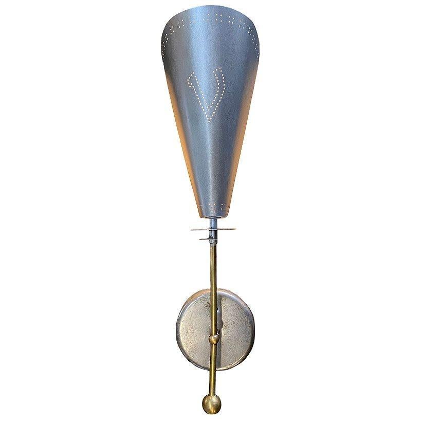 Mid-century era Googie brushed aluminum wall sconces with polished brass featuring a torchiere with a large folded aluminum shade connected to a brass. There is a dot pattern forming a 