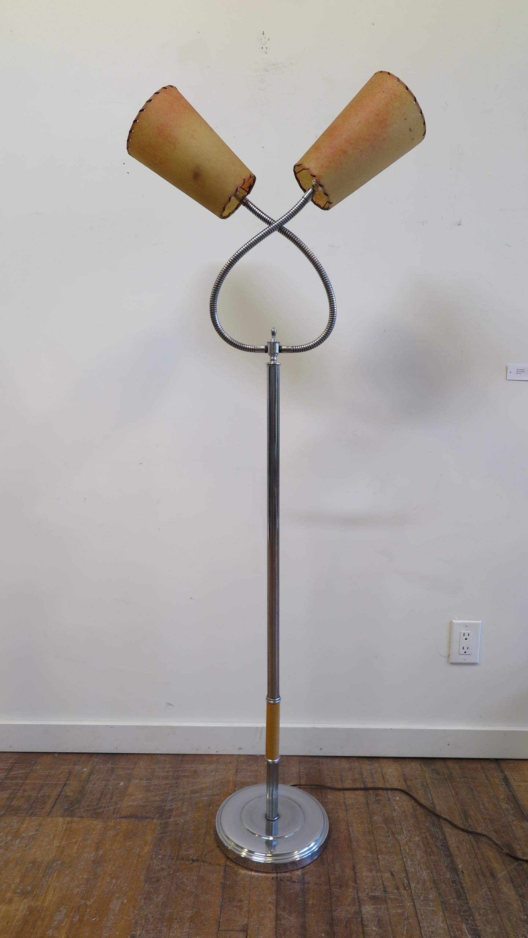 Midcentury chrome double goose heck floor lamp. Chrome reeded pole with two articulating goose neck fixtures having original parchment shades. Can be positioned in various arrangements using the two goose necks. The goose necks are very