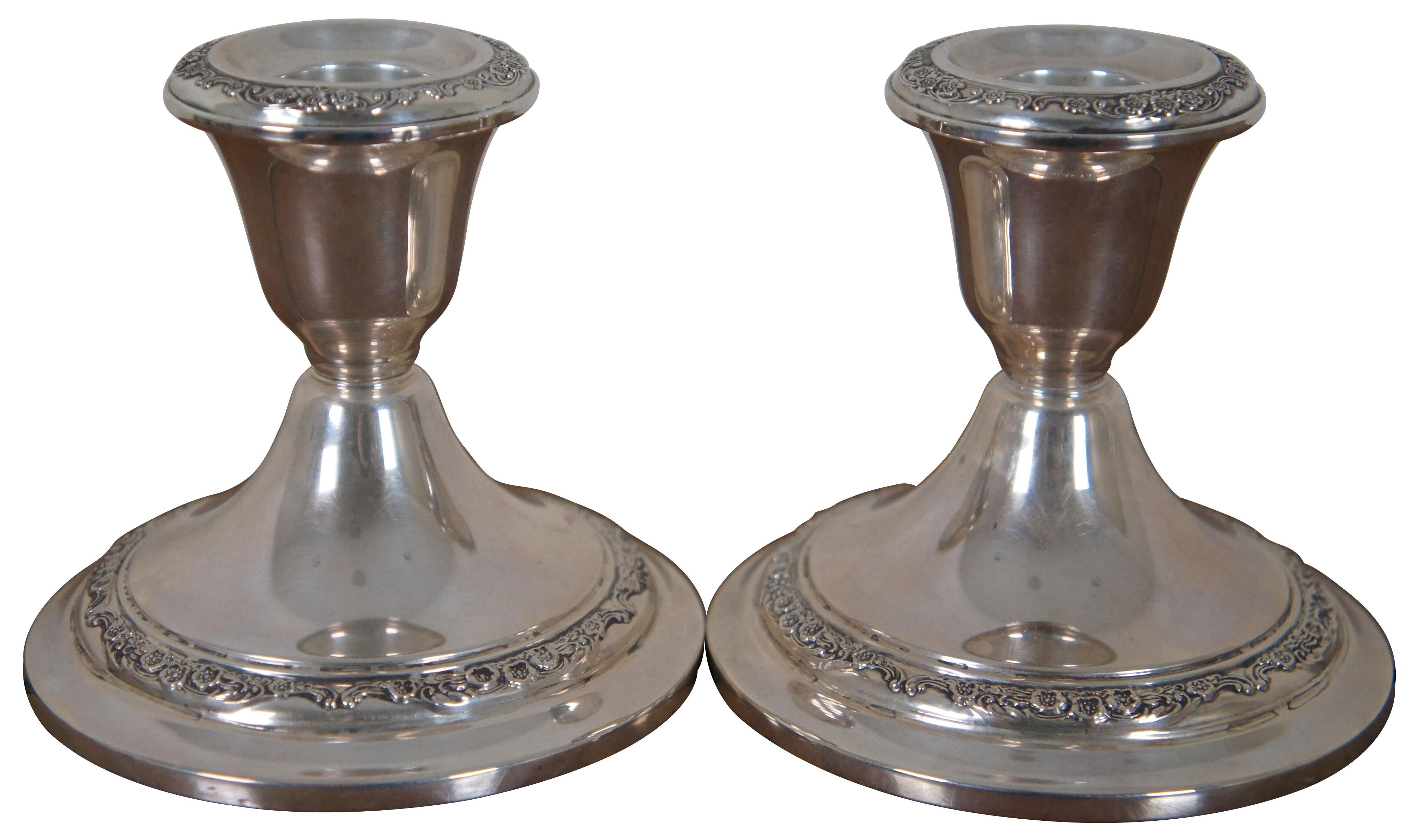 Pair of mid-century Gorham reinforced sterling silver candlestick holders decorated with bands of flowers. 960.

