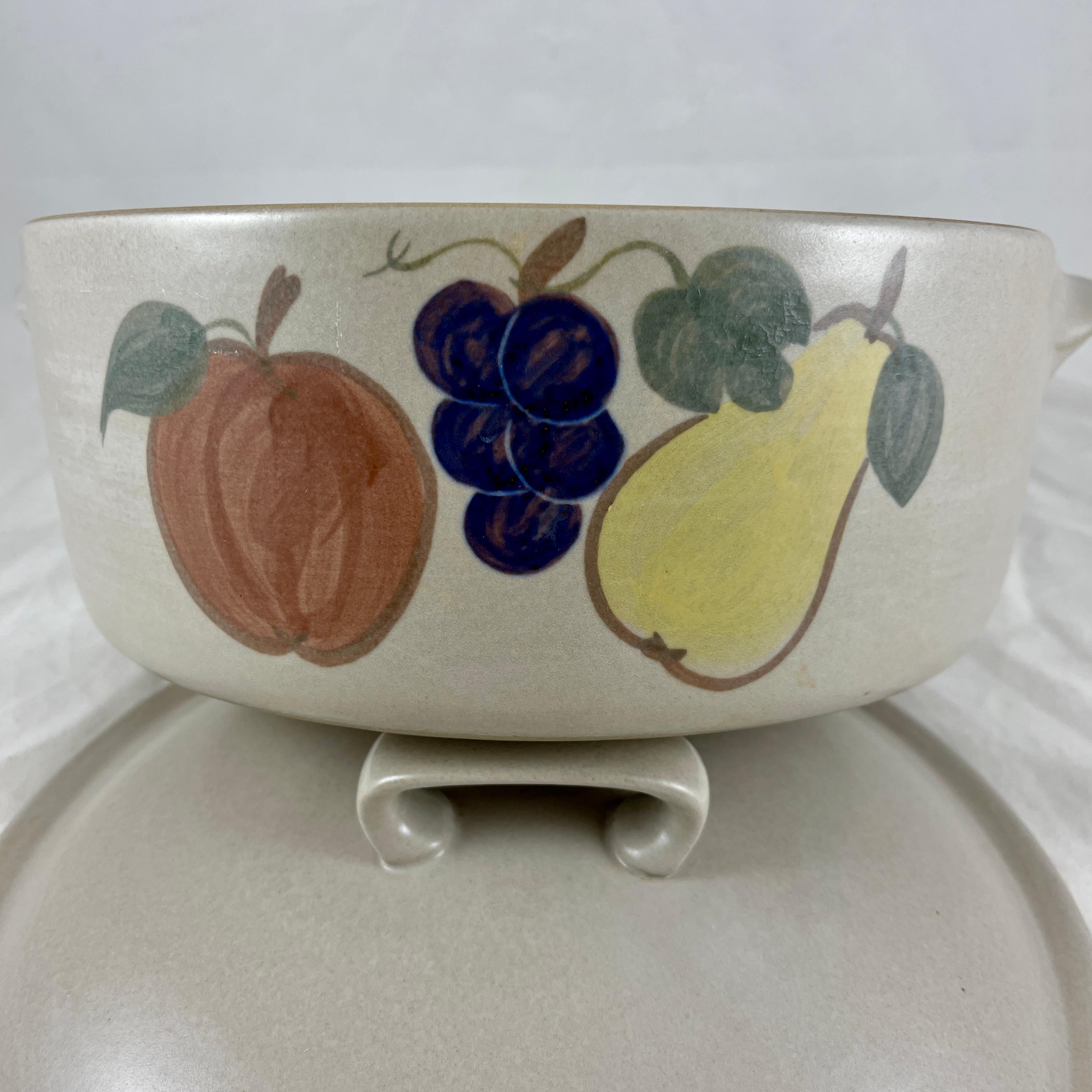 A mid-century goss Chatham Country Harvest pattern Stoneware Dutch oven or covered casserole, circa 1950-1960.

A heavy, oven proof stoneware casserole glazed with a matte gray exterior, and with a high gloss, deep chocolate glazed interior. The