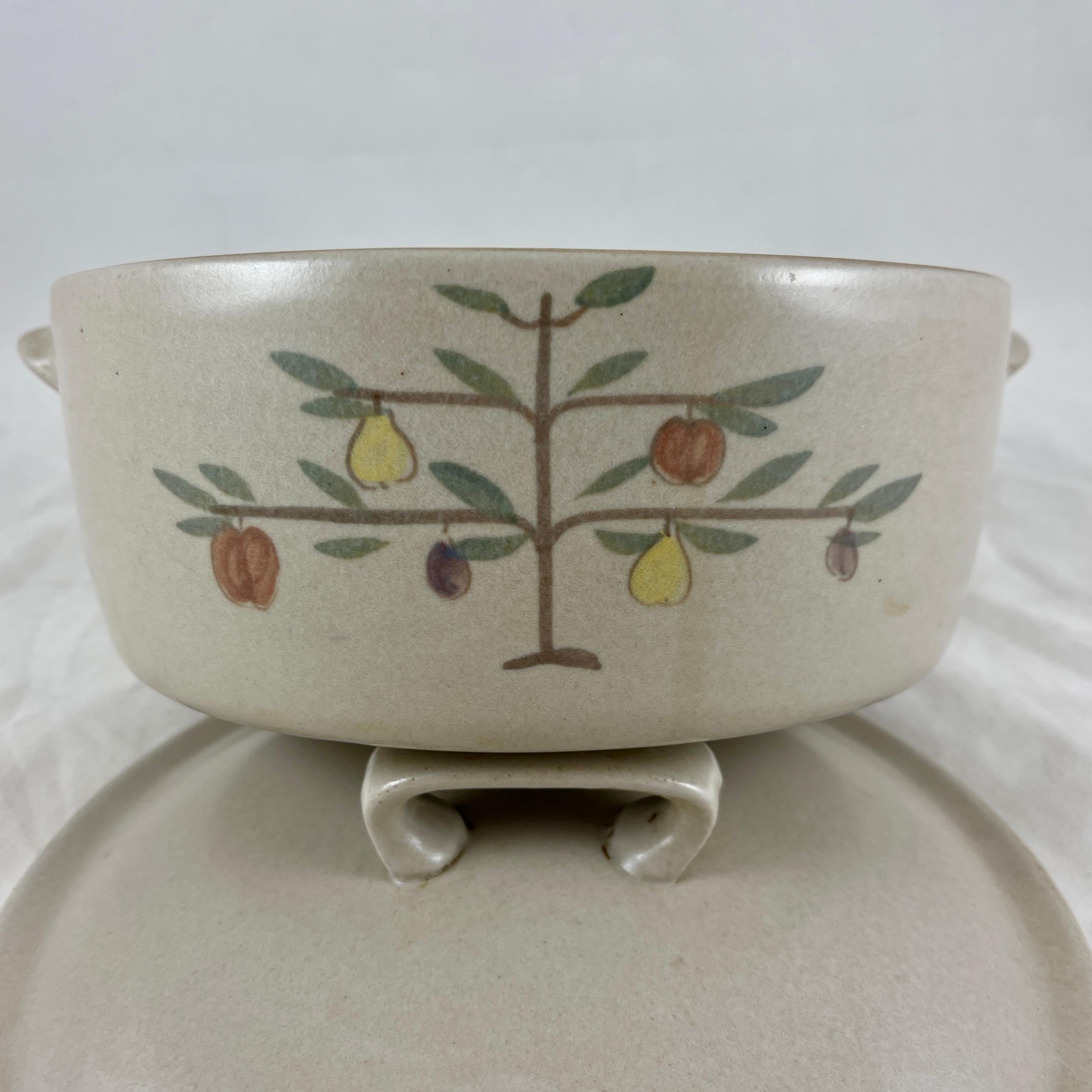 A Mid-Century Goss Chatham Tree of Life pattern Stoneware Dutch oven or covered casserole, circa 1950-1960.

A heavy, oven proof stoneware casserole glazed with a matte gray exterior, and with a high gloss, deep chocolate glazed interior. The base