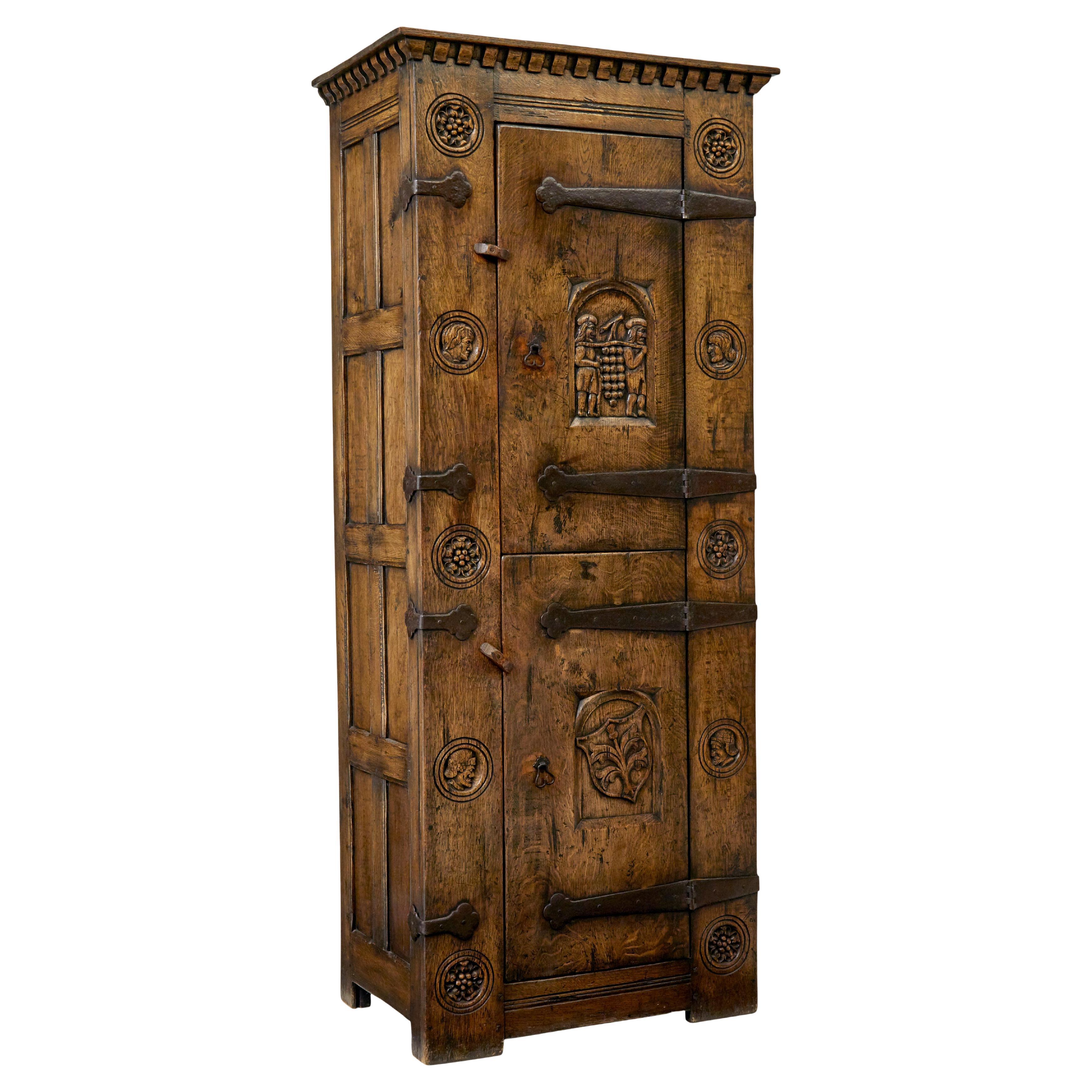 Mid century gothic revival carved oak hall cupboard