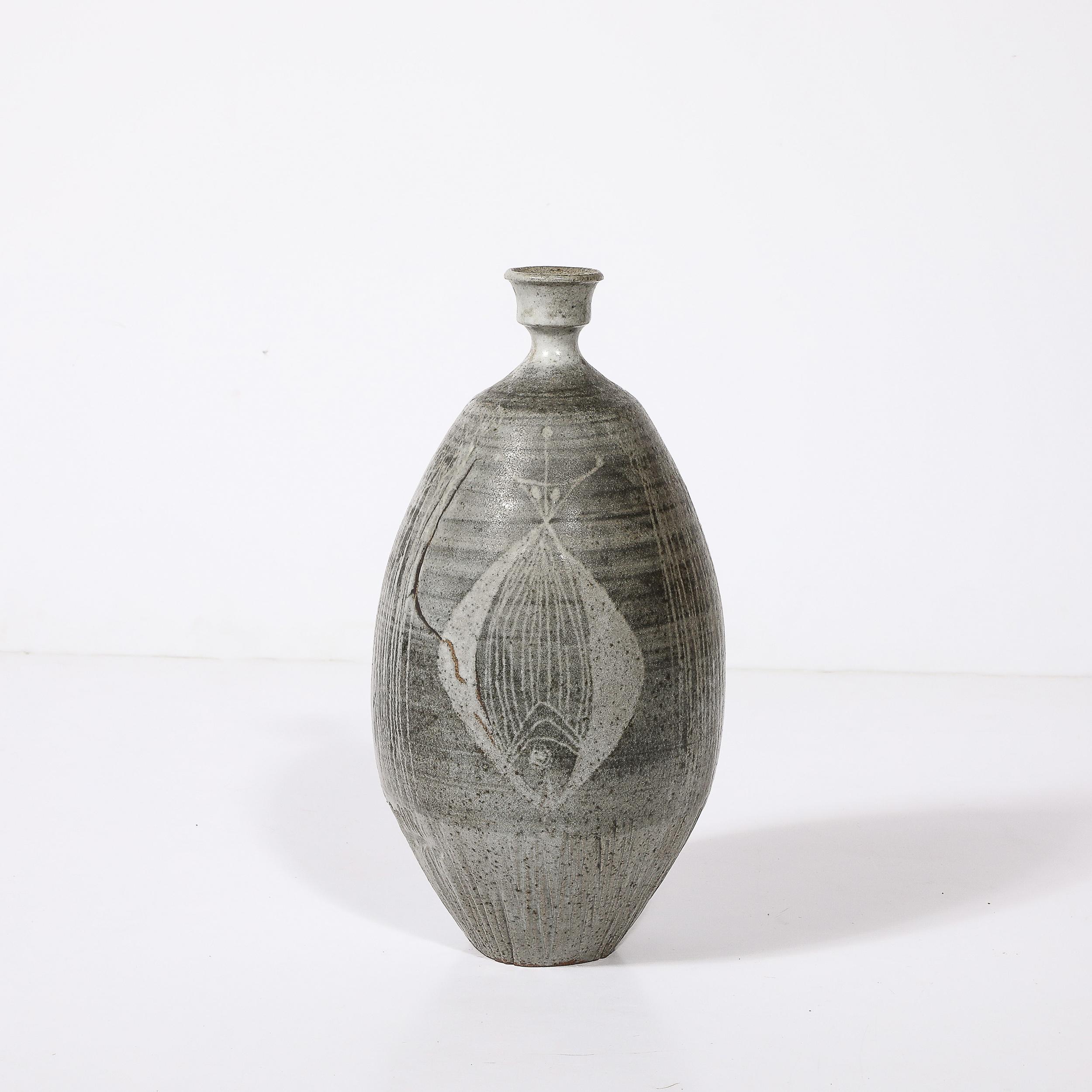 This reserved yet highly detailed Mid-Century Modernist Graphite Glazed Ceramic Vase W/ Fish Motif signed Antonio Prieto originates from the United States, C. 1950. Features a rounded body with a swooping taper at the neck, then expanding again