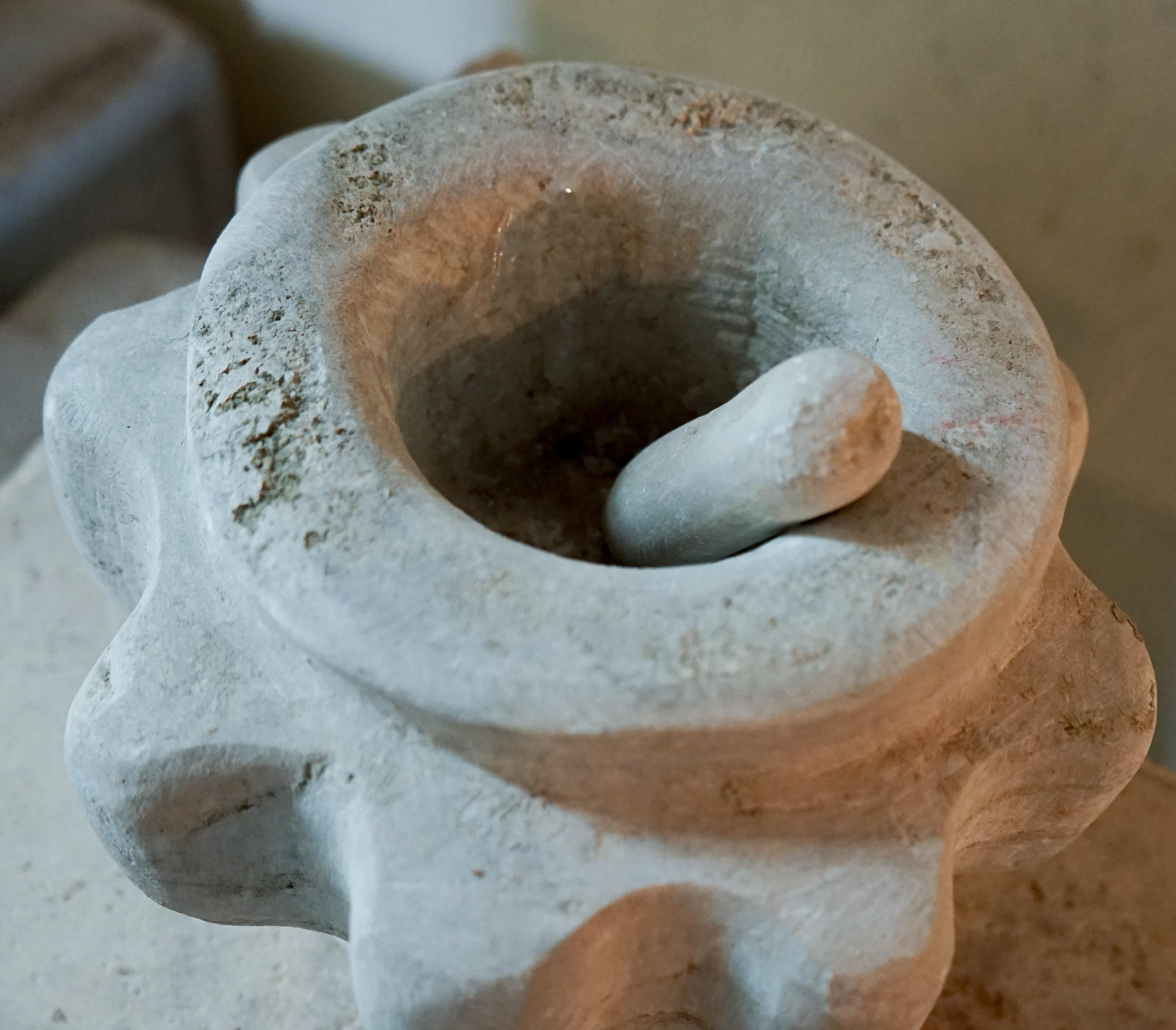 Limestone mortar and pestle from the Greek Islands, historically used for medicinal purposes or in the kitchen for crushing herbs.

Measurements: 11'' D x 6'' H.